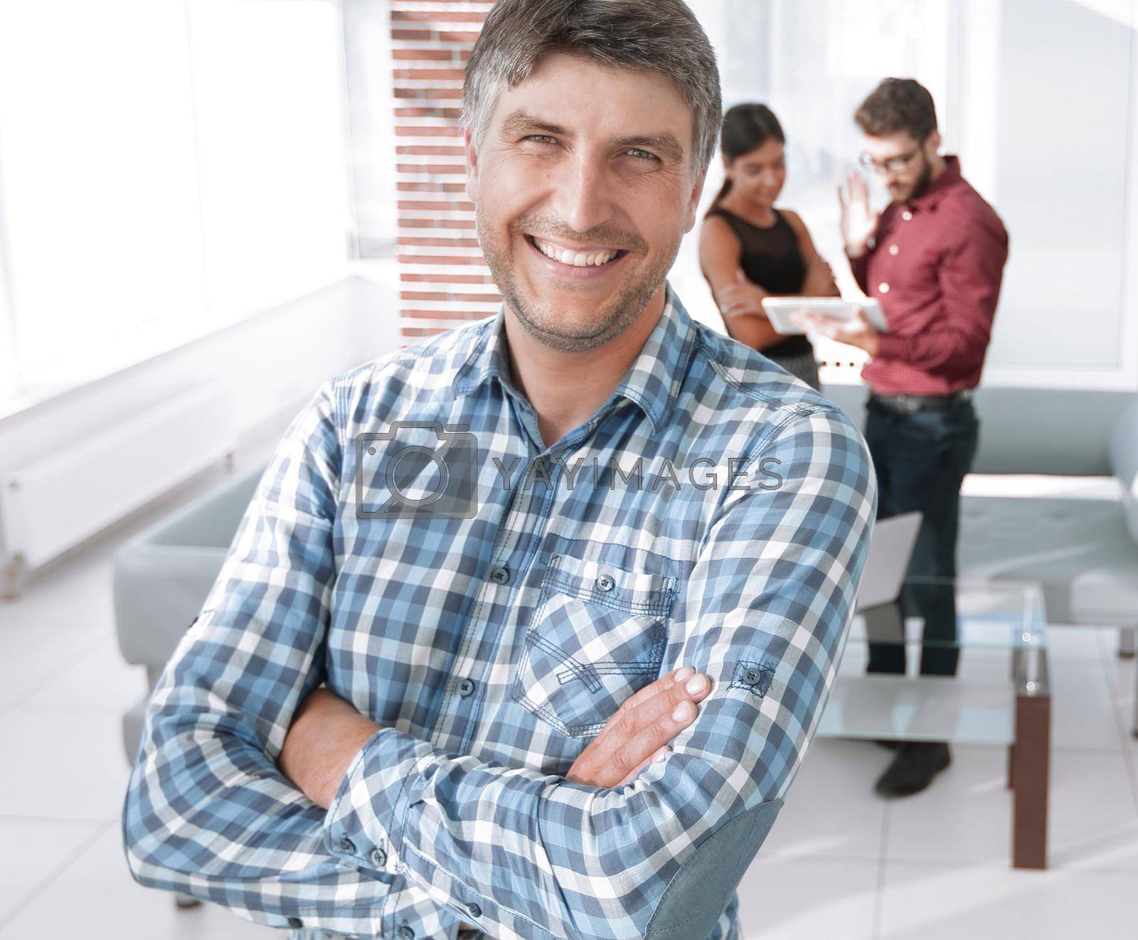 Royalty free image of Smiling mature businessman in plaid shirt foreground by asdf