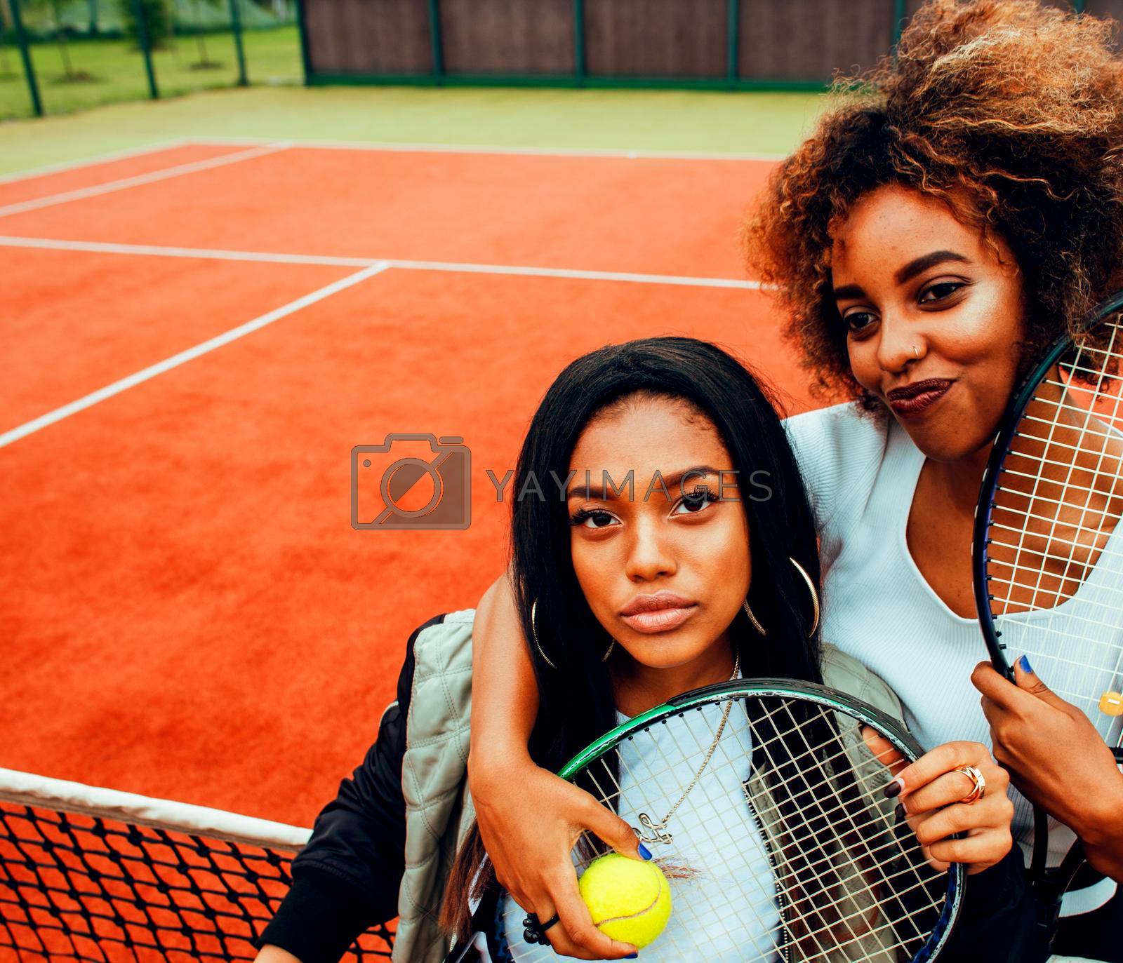 young pretty girlfriends hanging on tennis court, fashion stylish dressed swag, best friends happy smiling together lifestyle close up