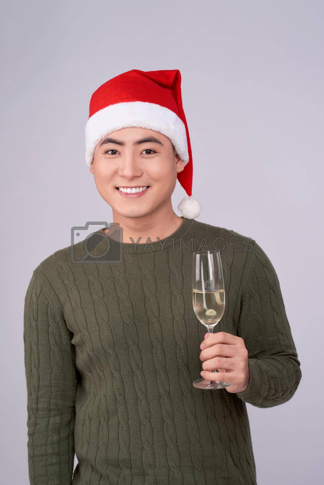 Celebration and New Year. Asian man holds glass of champagne