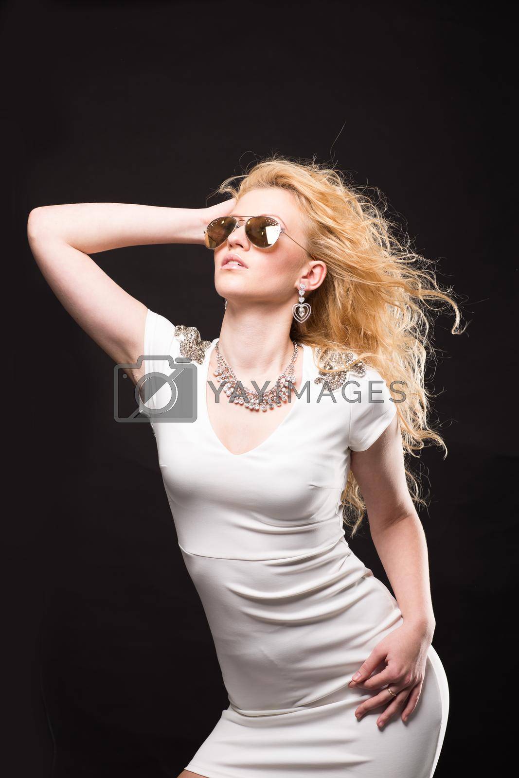 Royalty free image of portrait of beautiful blonde girl on black background by SmartPhotoLab
