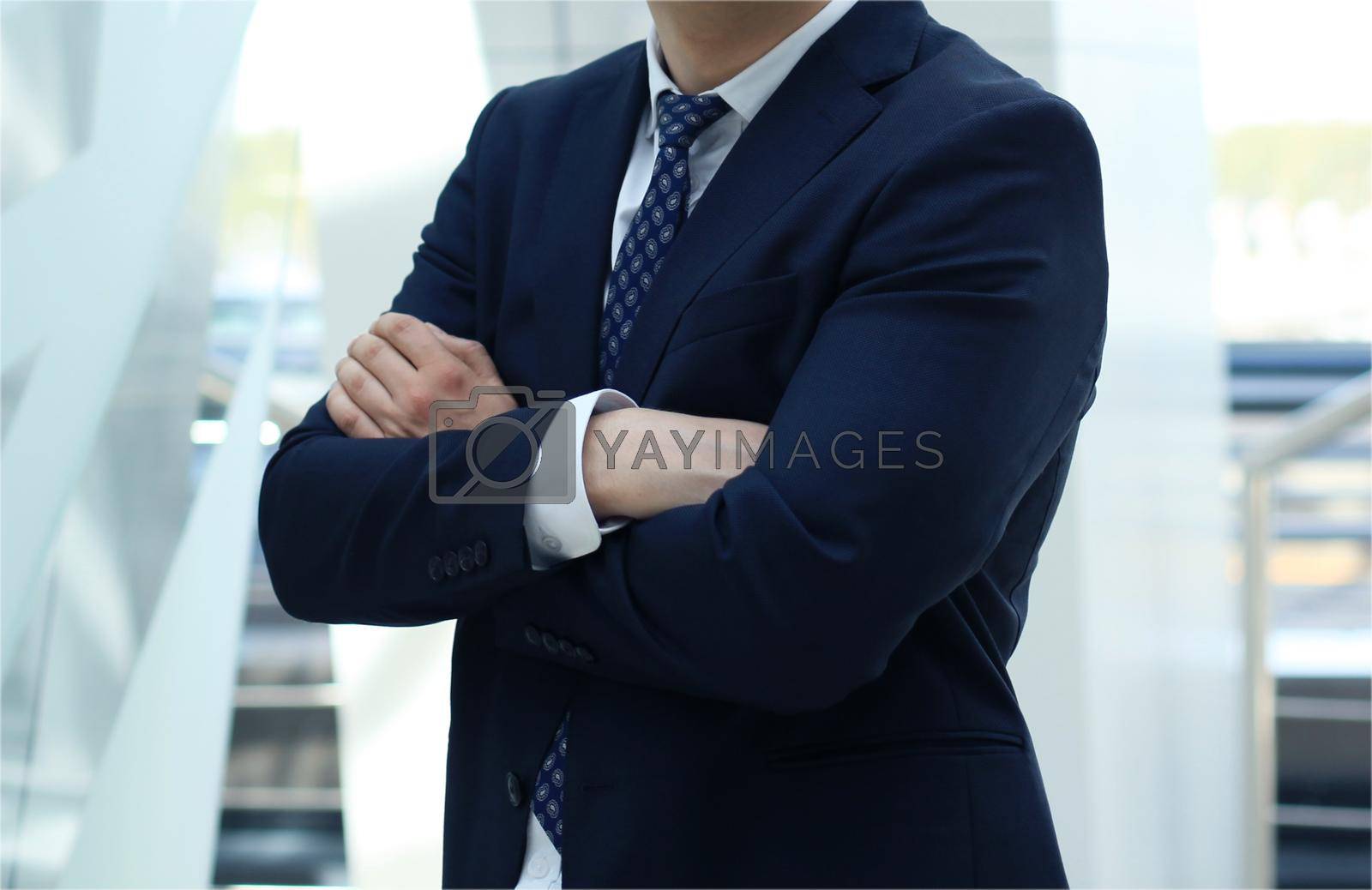Royalty free image of suited man with arms crossed by tsyhun