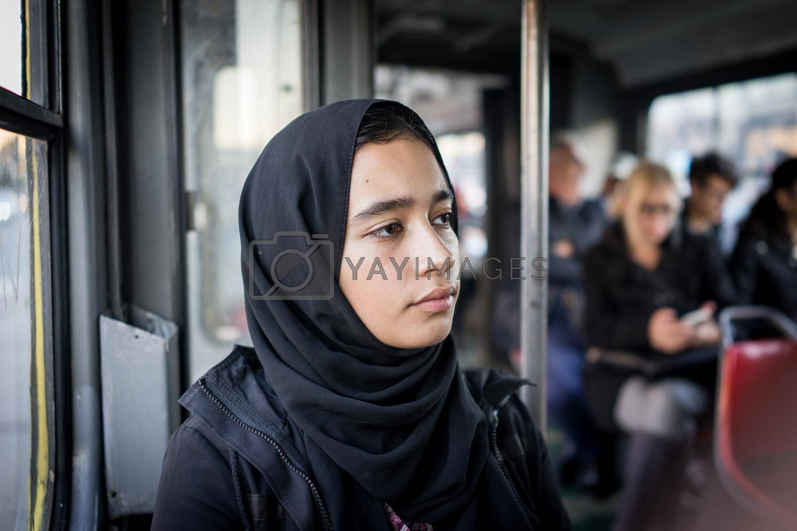 Middle Eastern girl riding public transport in the city