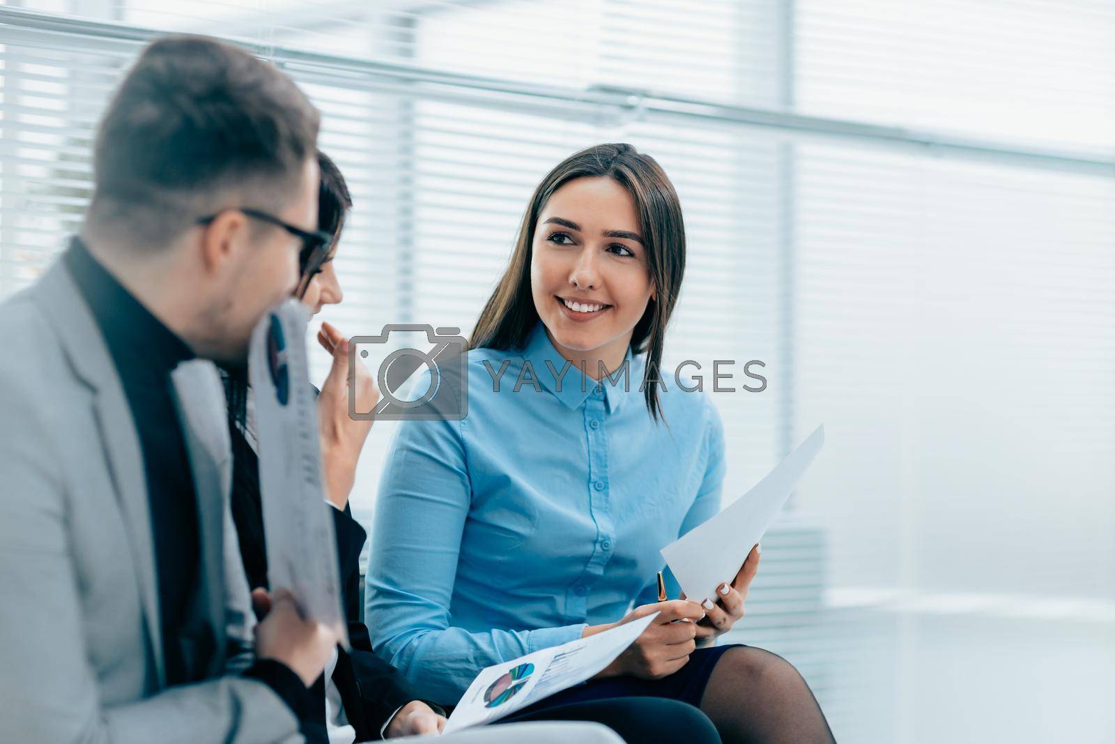 Royalty free image of group of employees discussing the terms of an employment contract by SmartPhotoLab