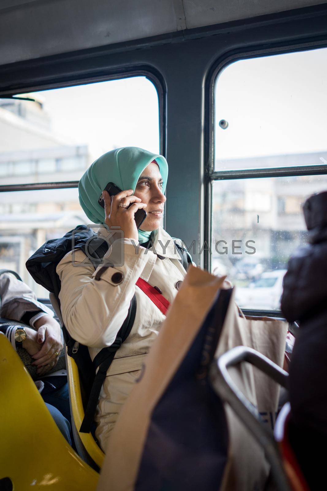 Muslim woman riding public transport in the city