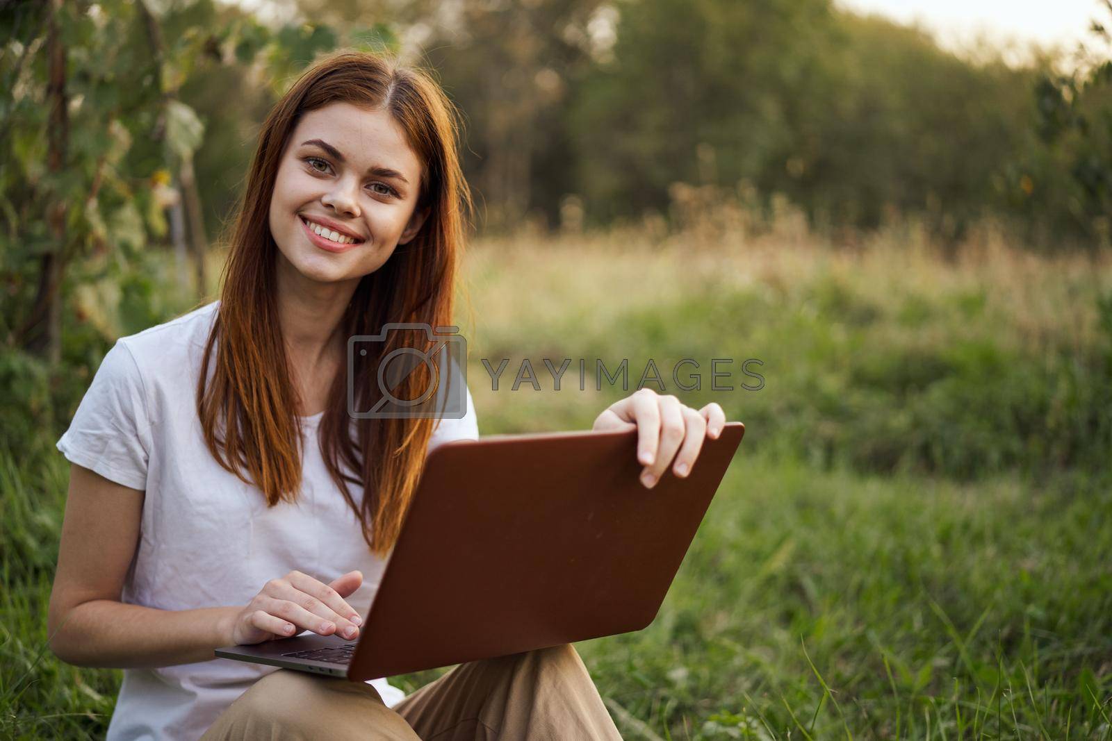 cheerful woman outdoors laptops communication internet. High quality photo