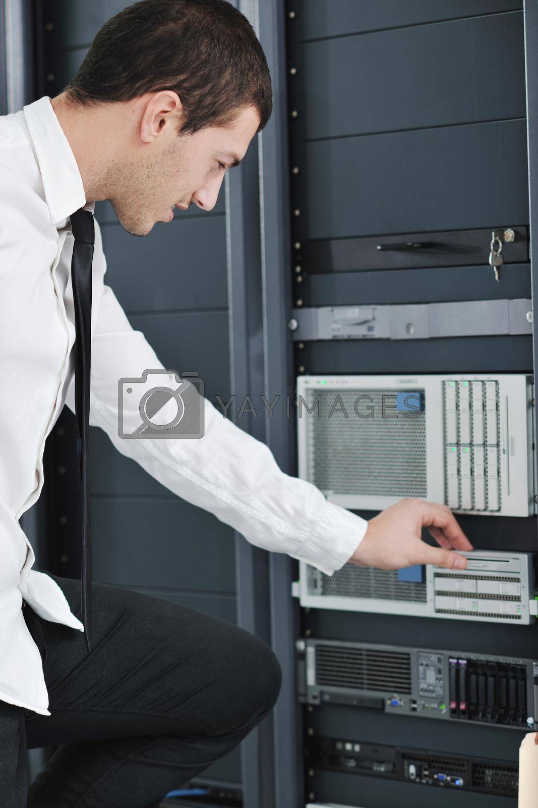 Royalty free image of young engeneer in datacenter server room by dotshock