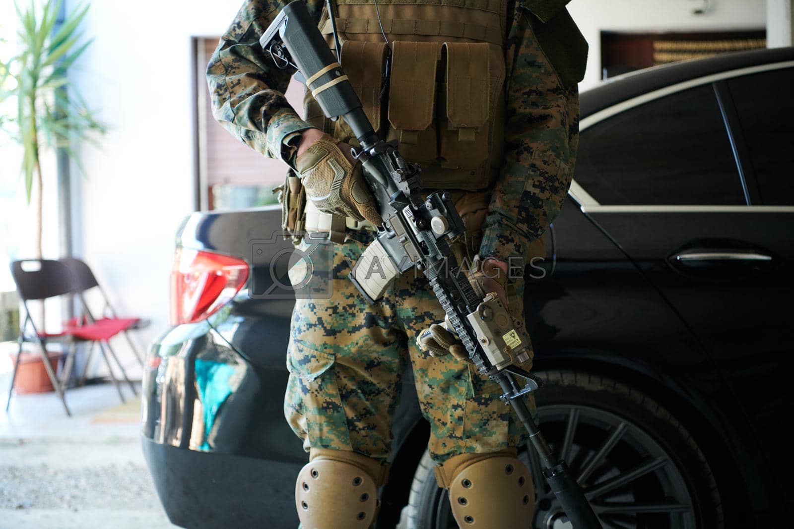 Royalty free image of soldier protecting armored luxury buletproof vehicle by dotshock