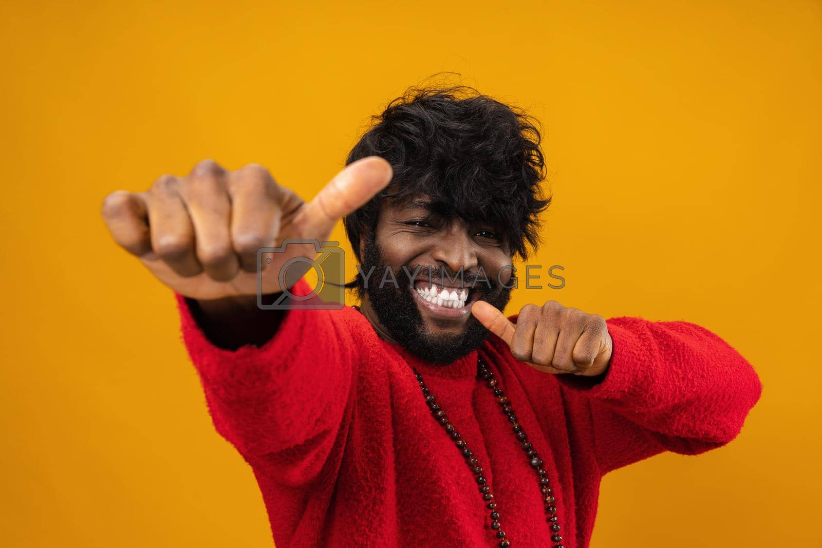 Royalty free image of Happy young black man giving thumbs up by Fabrikasimf