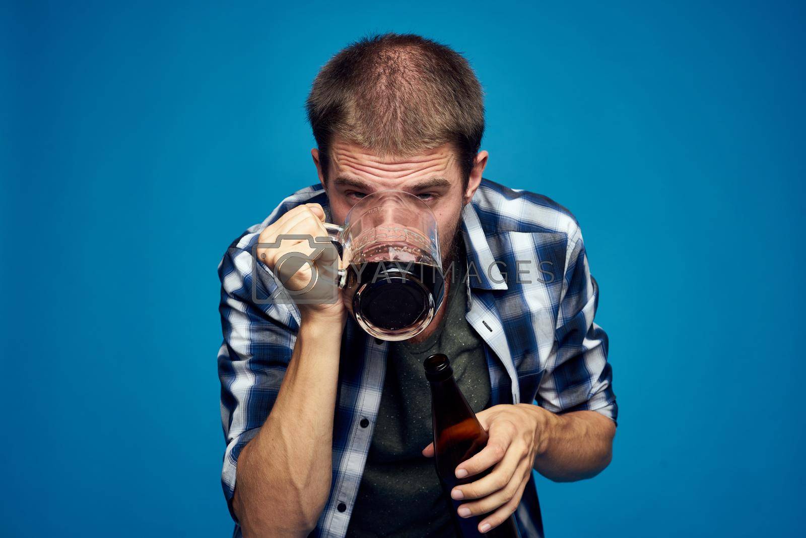 Royalty free image of drunk man alcoholism problems emotions depression blue background by Vichizh