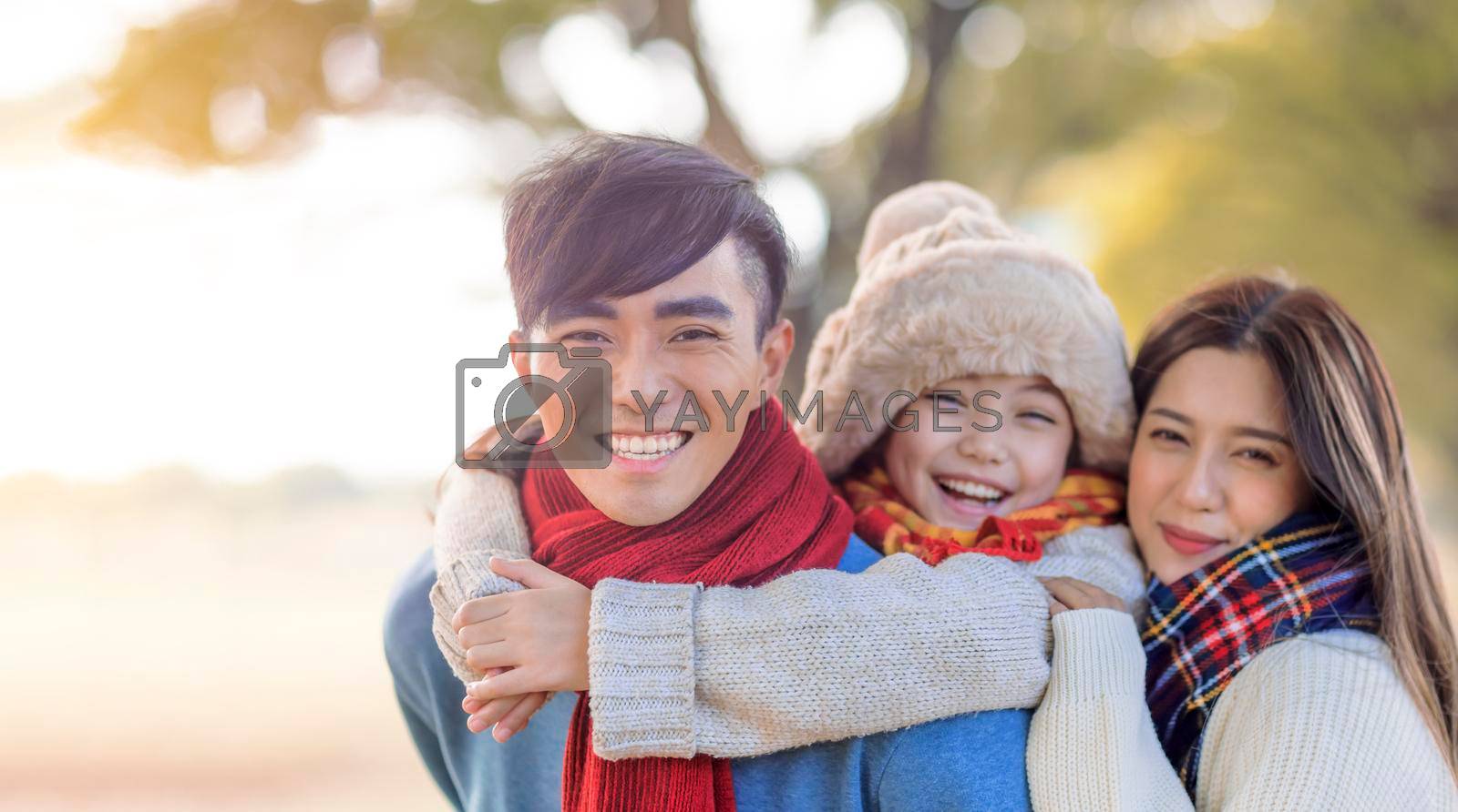Royalty free image of happy asian family in winter park by tomwang