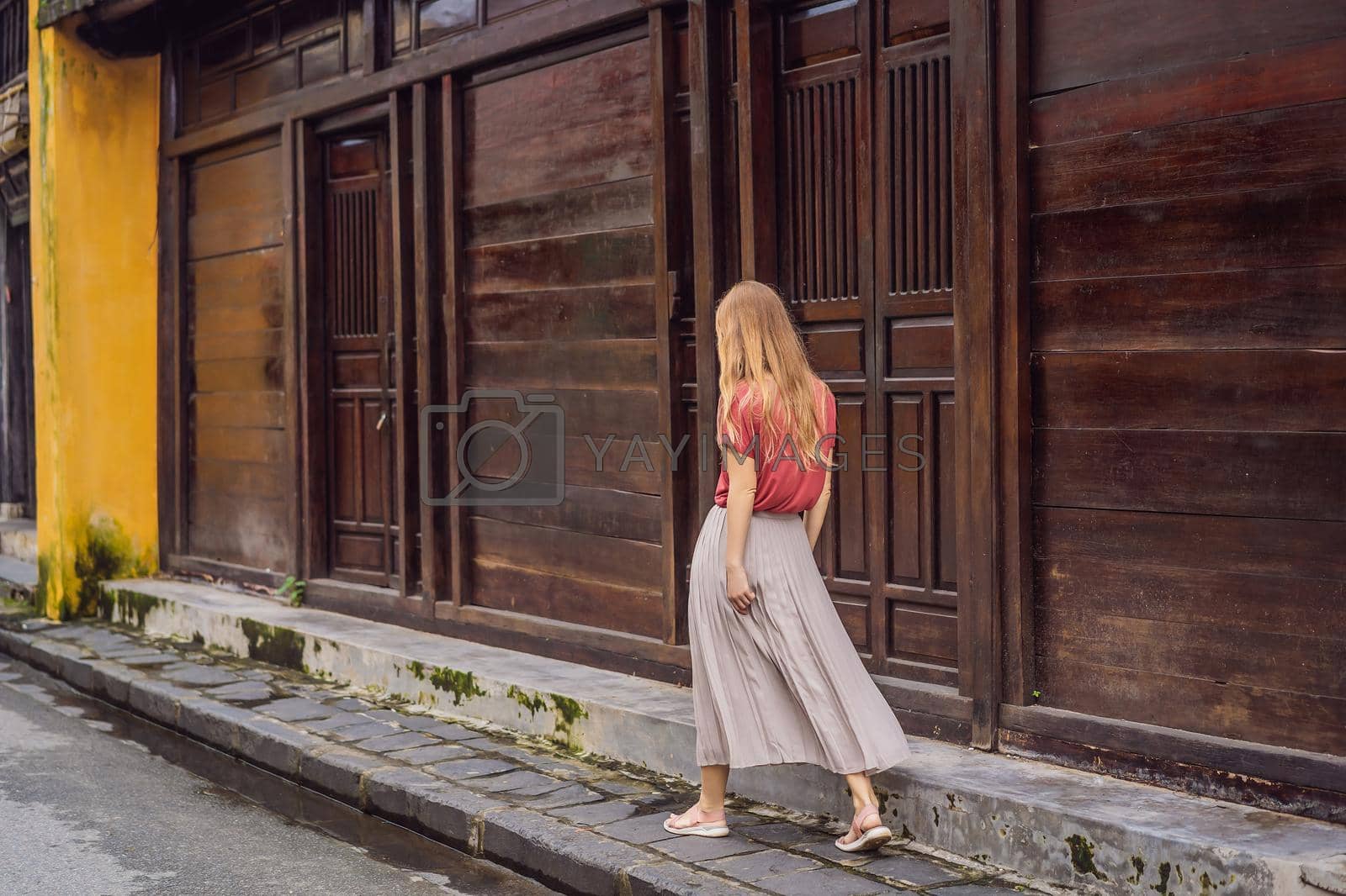 Royalty free image of Woman tourist on background of Hoi An ancient town, Vietnam. Vietnam opens to tourists again after quarantine Coronovirus COVID 19 by galitskaya