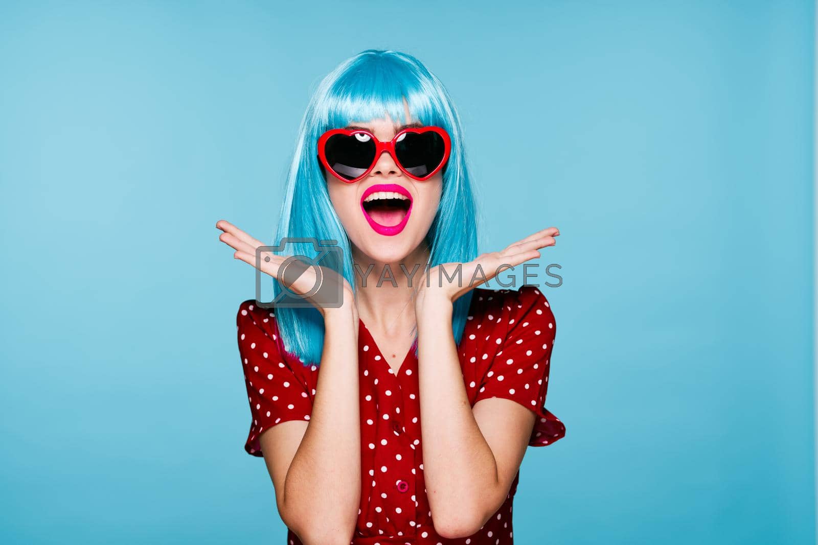 emotional woman blue wig sunglasses posing fashion. High quality photo