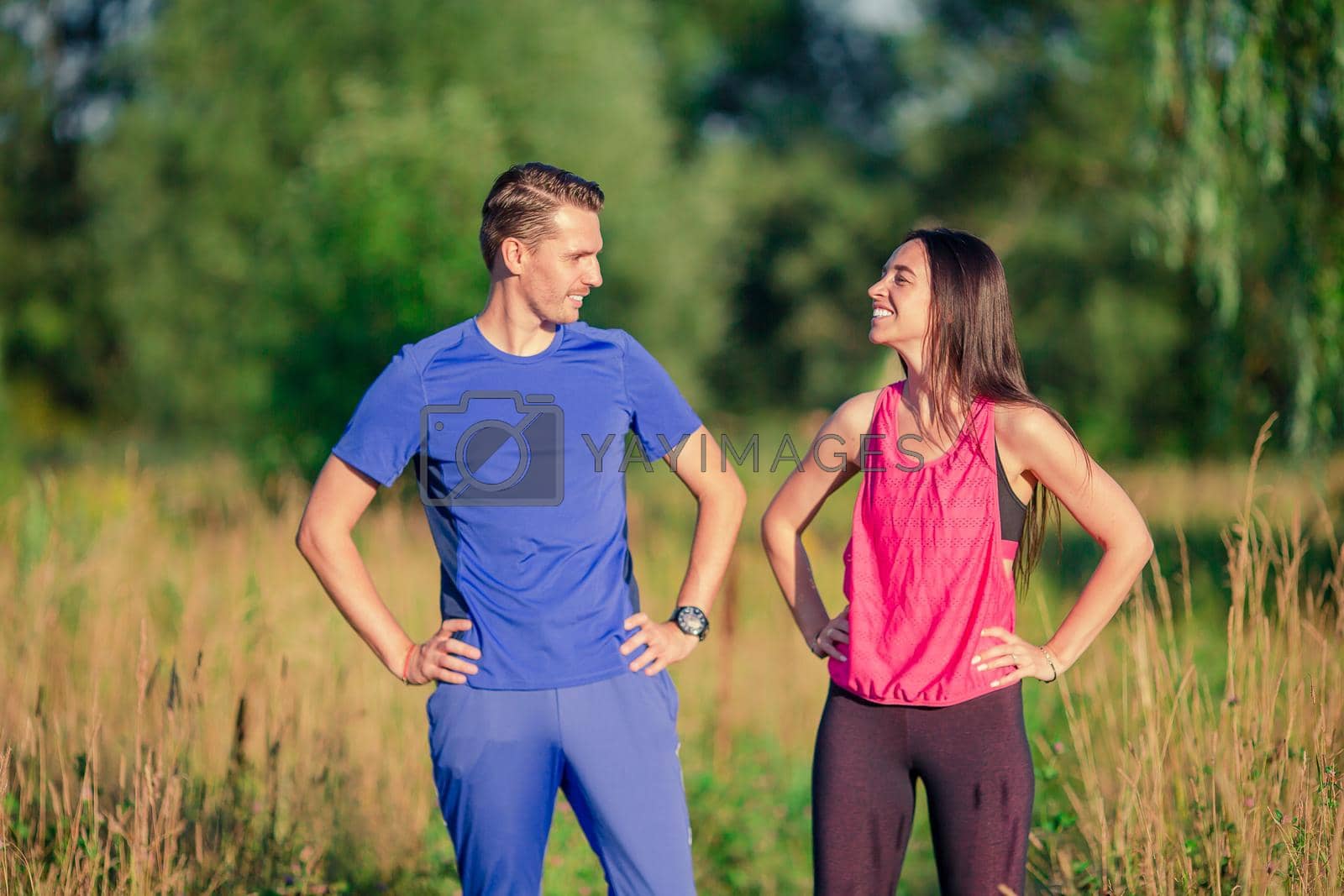 Active sport couple running in park. Healthy lifestyle fitness concept