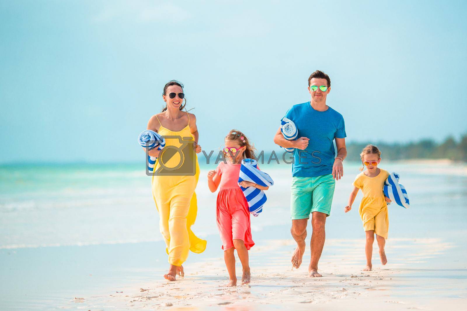 Royalty free image of Young family on vacation on the beach by travnikovstudio