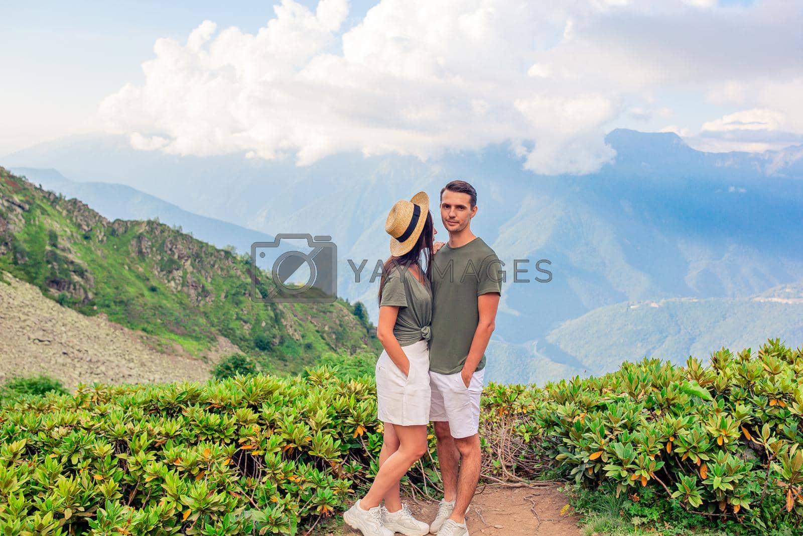Royalty free image of Beautiful happy family in mountains in the background of fog by travnikovstudio