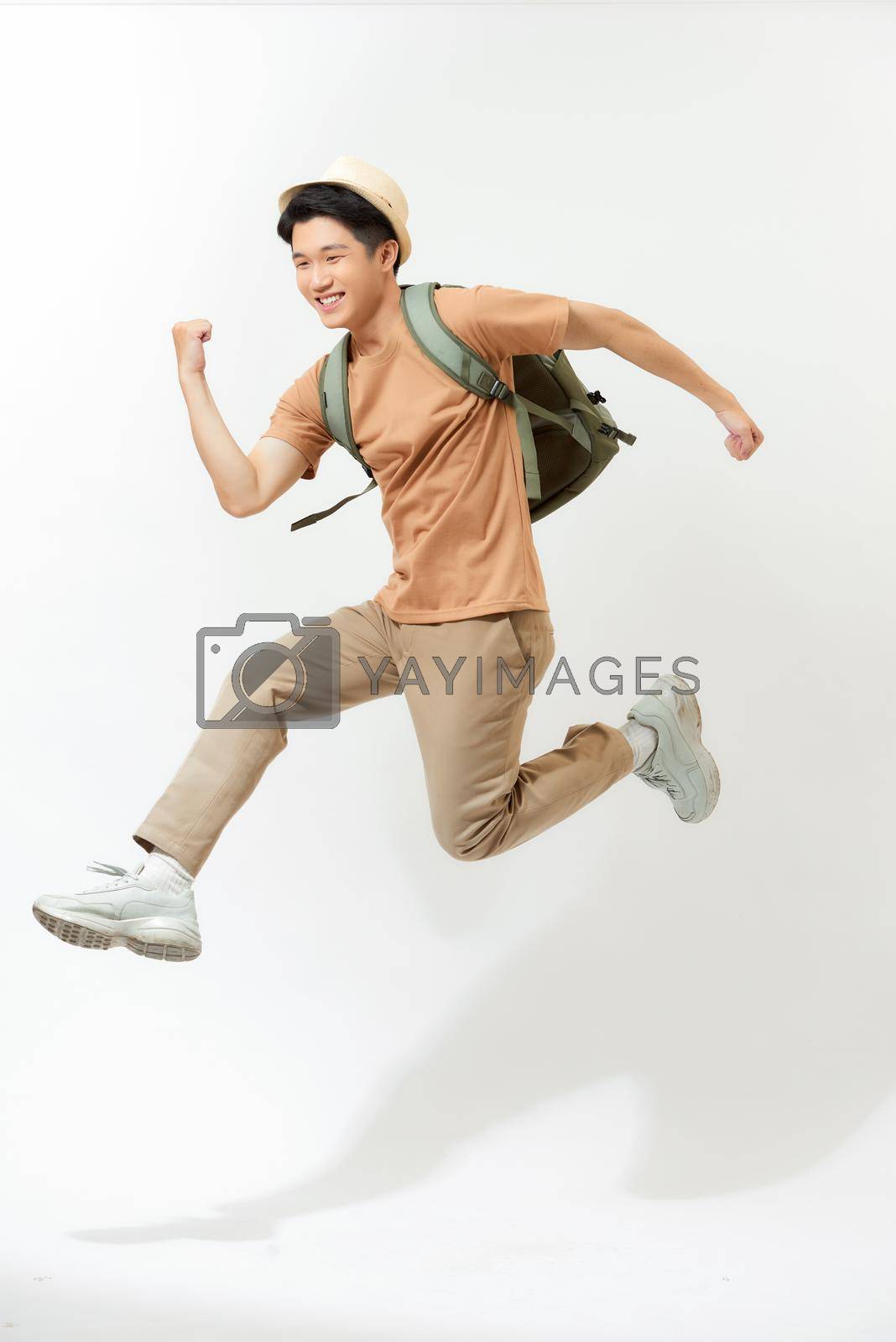 Royalty free image of Side view of excited traveler tourist man on white background by makidotvn