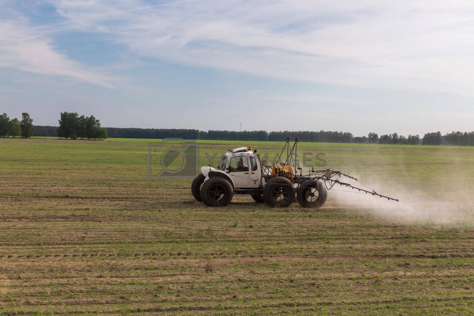 Royalty free image of Tractor sprays liquid chemical fertilizers by BY-_-BY