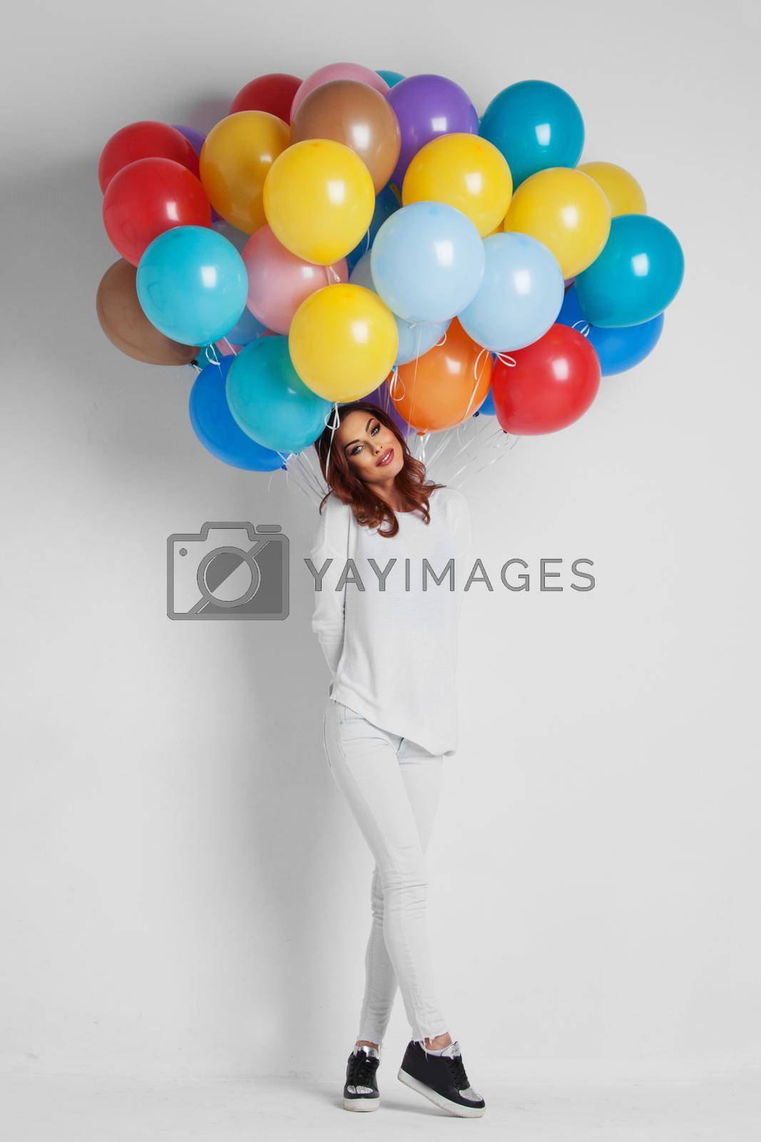 Royalty free image of Happy woman holding balloons by Yellowj