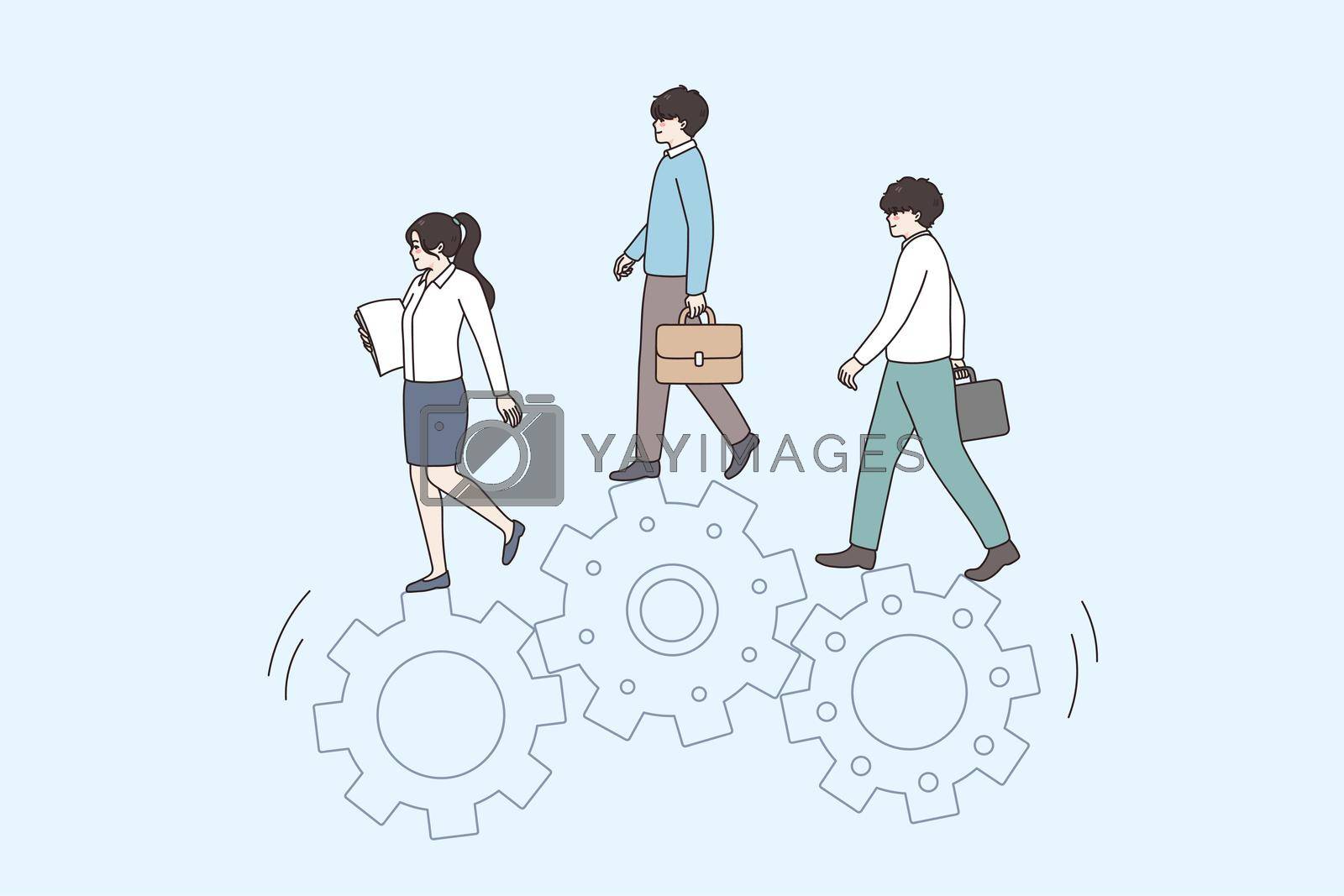 Royalty free image of Businesspeople walk together on gear wheels by Vasilyeva