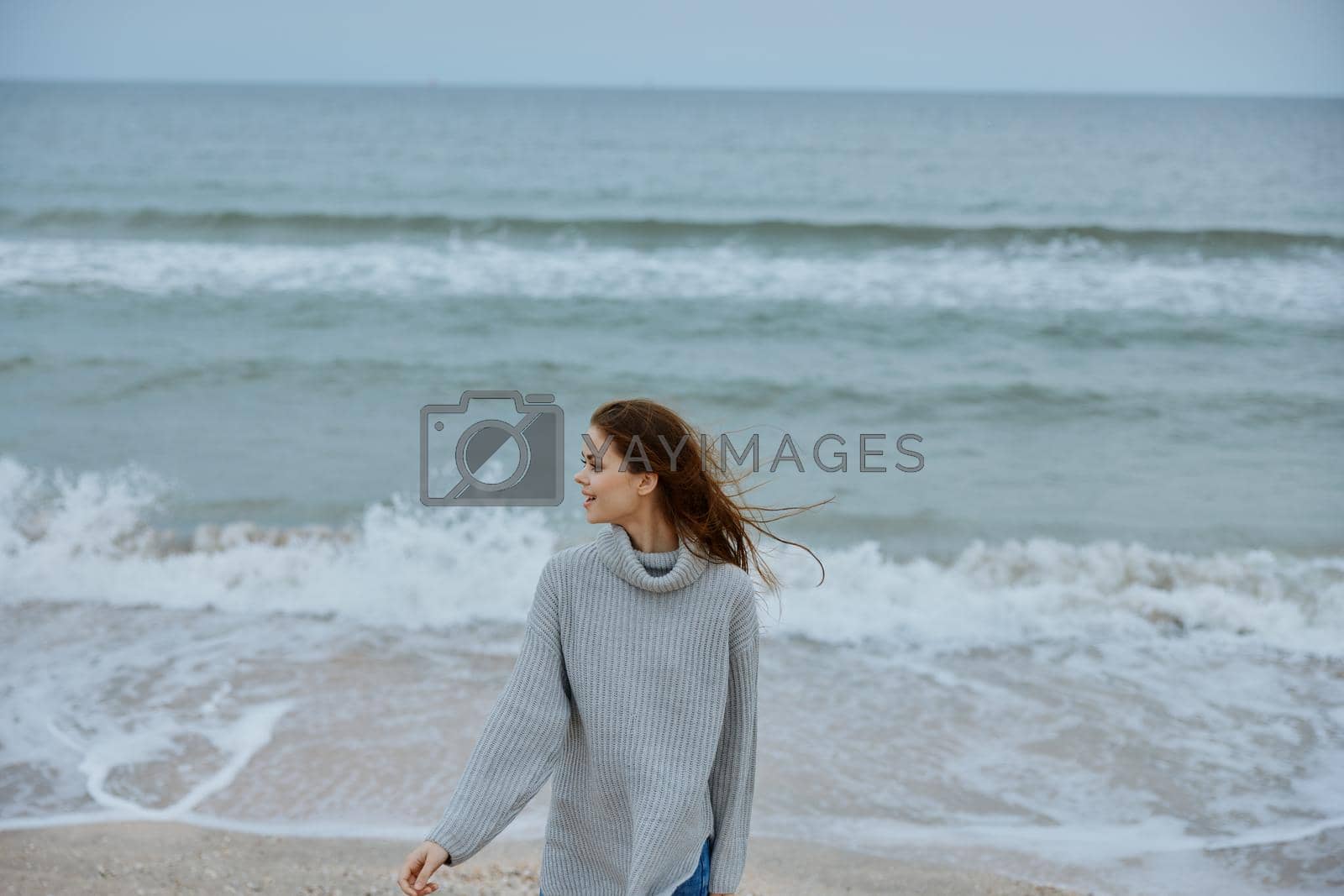 pretty woman alone by the ocean cloudy weather Happy female relaxing. High quality photo