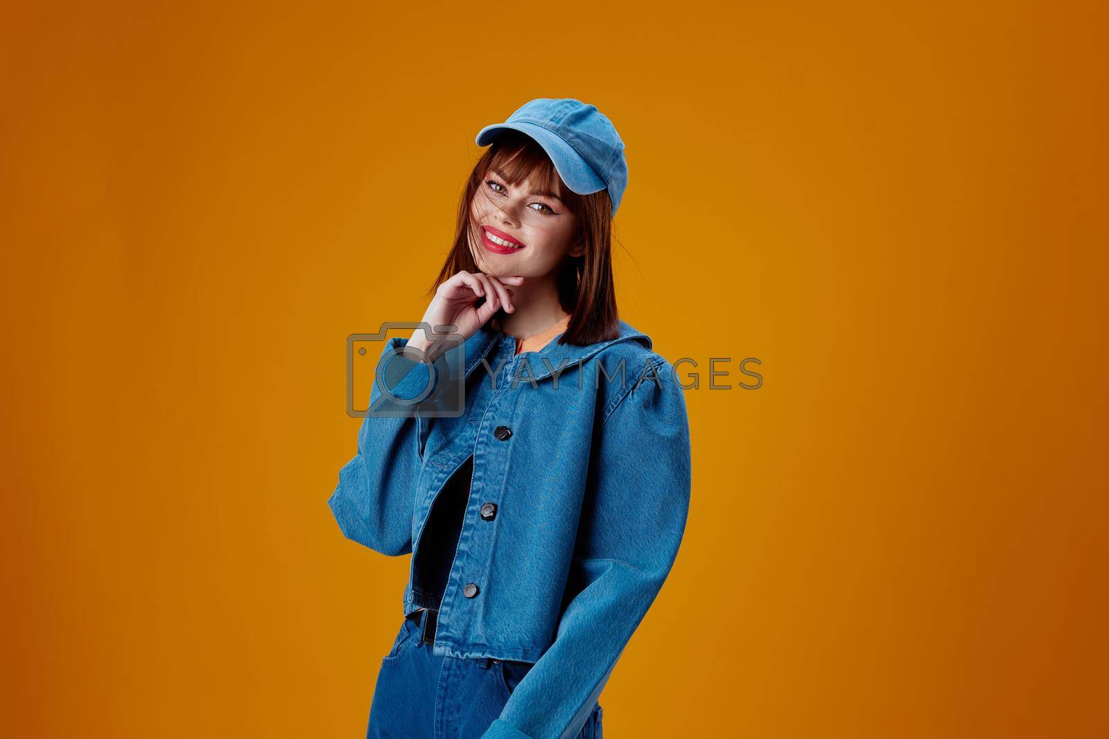 Beauty Fashion woman denim clothing fashion posing cap color background unaltered. High quality photo