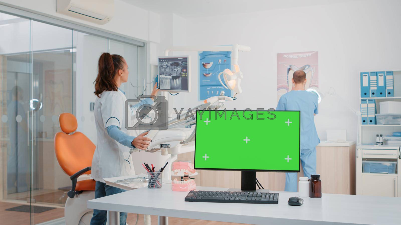 Dentist office with green screen on monitor and dental tools. Computer with isolated background and mockup template in cabinet for oral care and dentition. Medical space for dentistry