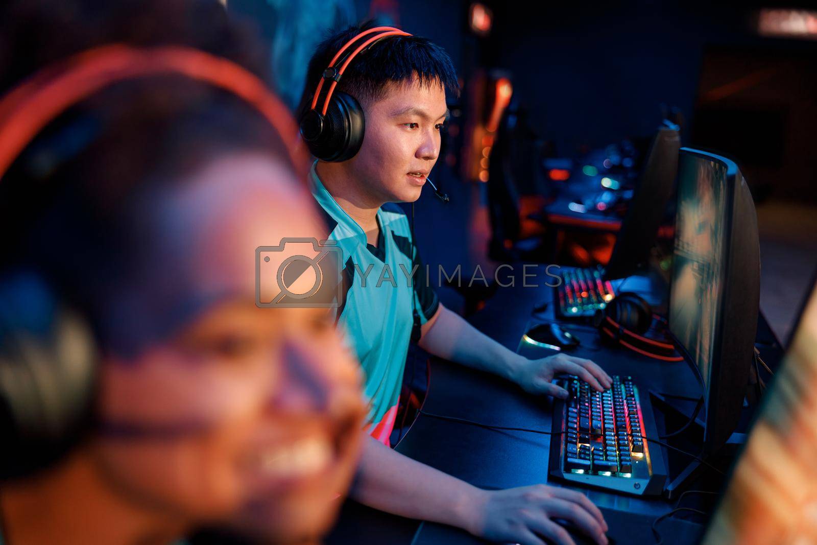 Royalty free image of Skillful gamer practicing in gaming arena in internet club by Yaroslav_astakhov