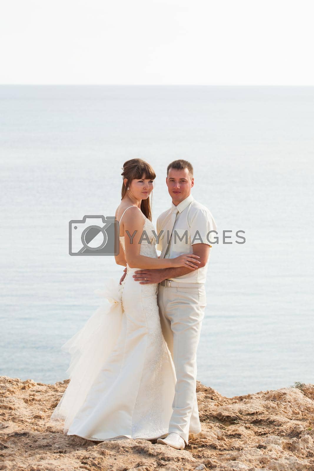 Royalty free image of Just married couple embraced by Satura86