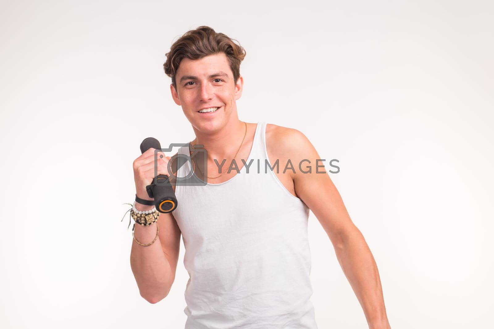 People, sport and fitness concept - sexy muscled man holding dumbbell on white background.