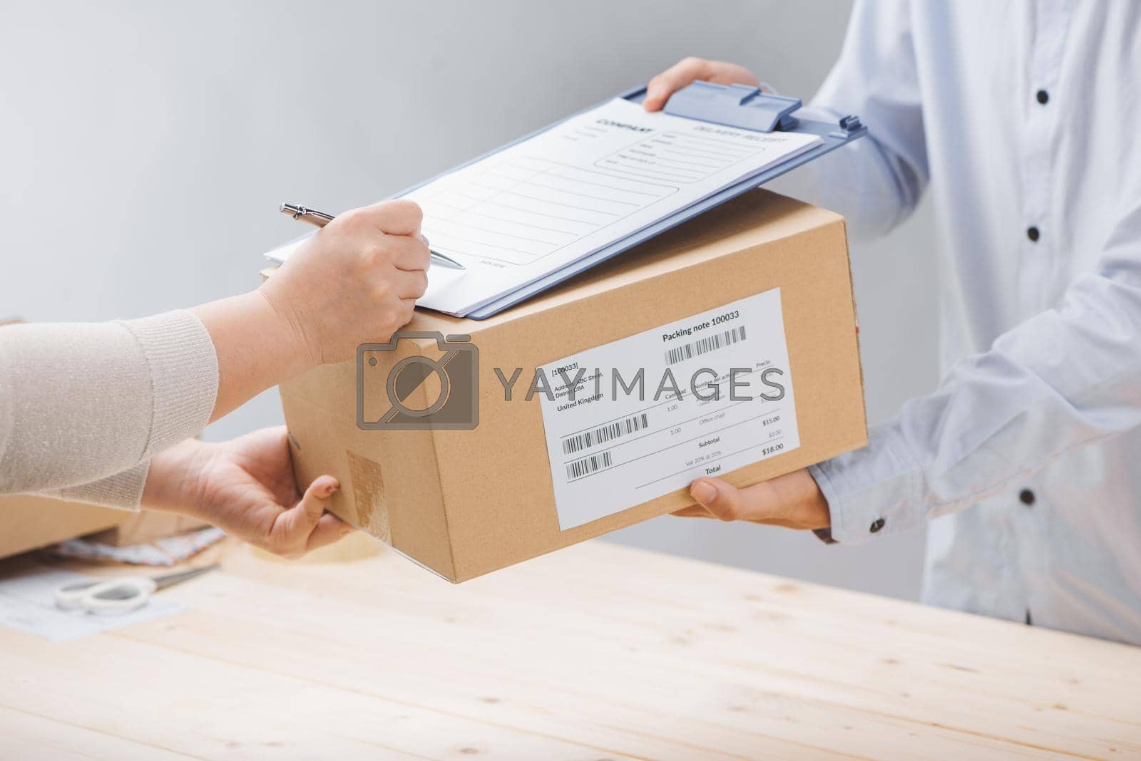 Royalty free image of Woman signing receipt of delivery package, close up by makidotvn