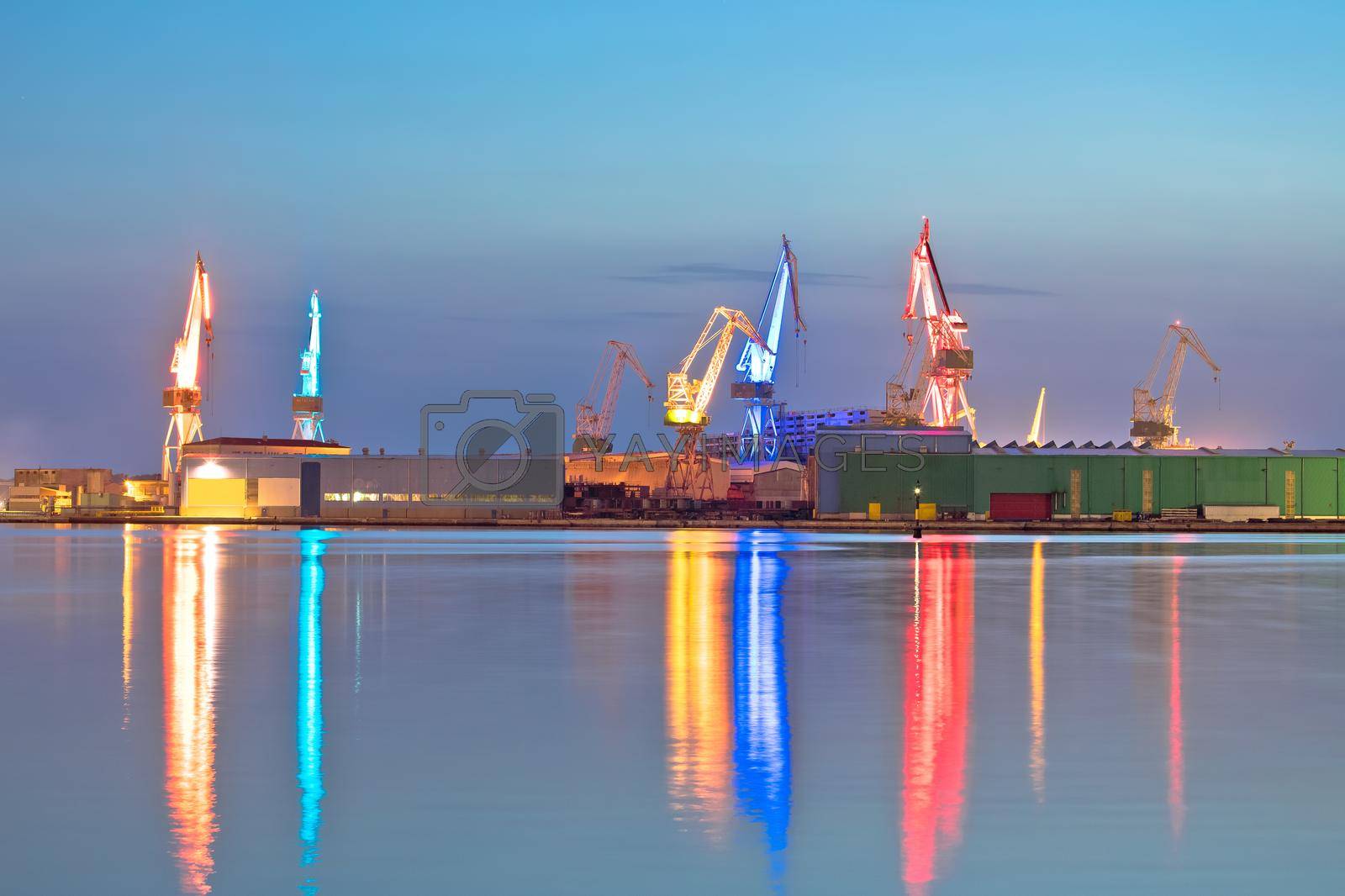 Royalty free image of City of Pula shipyard illuminated cranes evening view by xbrchx