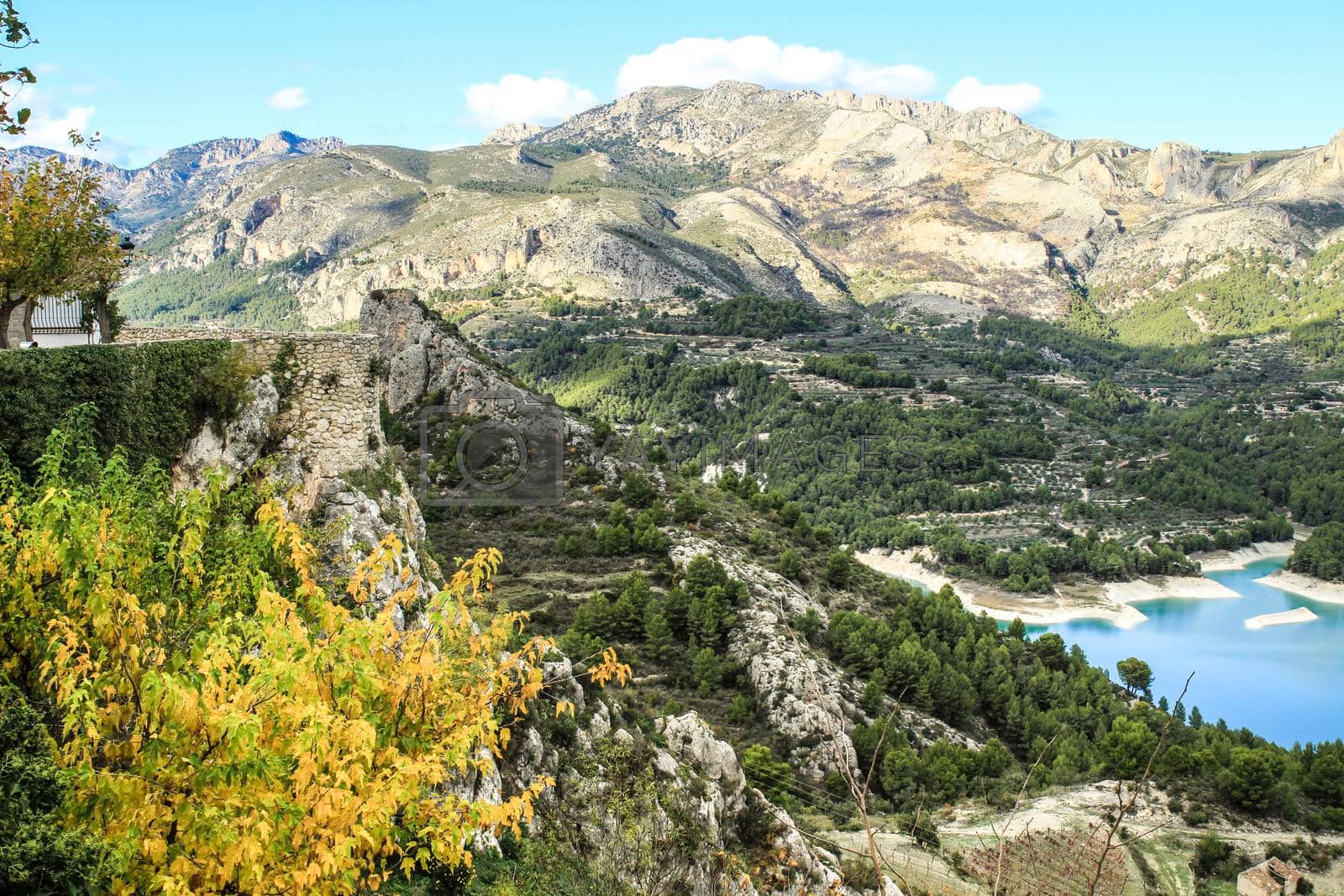 Royalty free image of Guadalest village surrounded by vegetation and the Castle by soniabonet