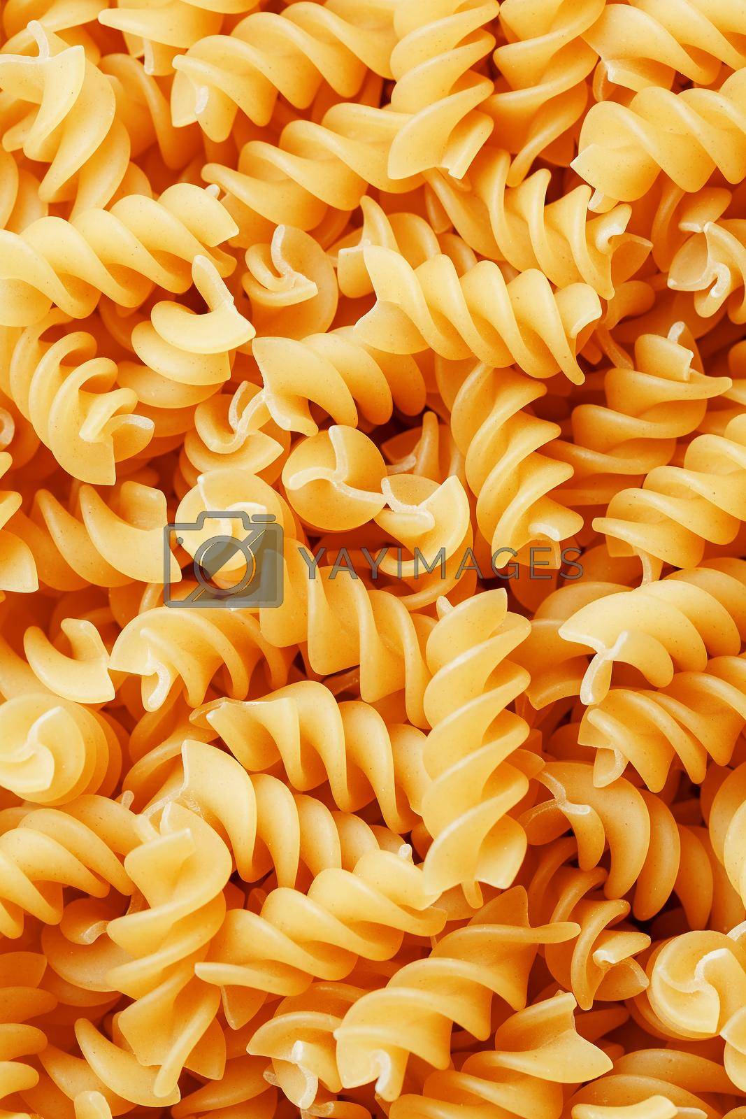 Royalty free image of Background texture and pattern of boiled egg noodles in a spiral or pasta spaghetti screw. in full frame. View from above by AlexGrec