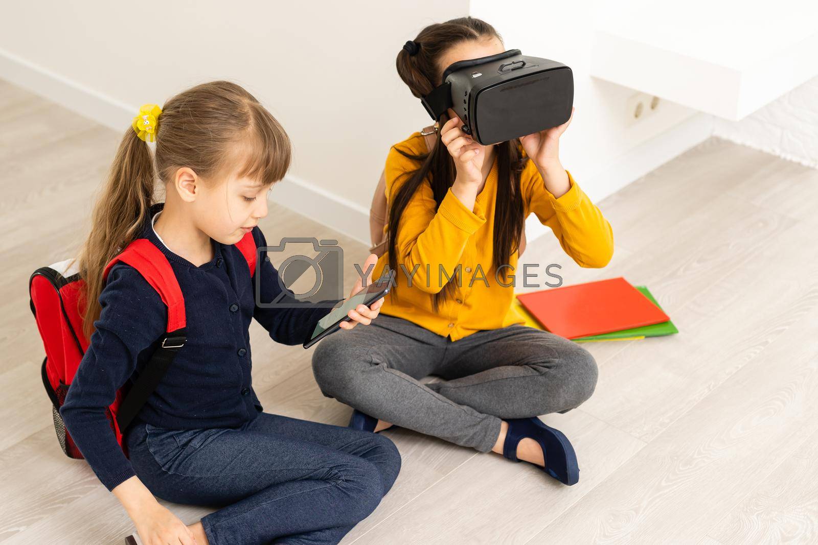 Two girls in headset virtual vr reality. Childhood kids education lifestyle concept.