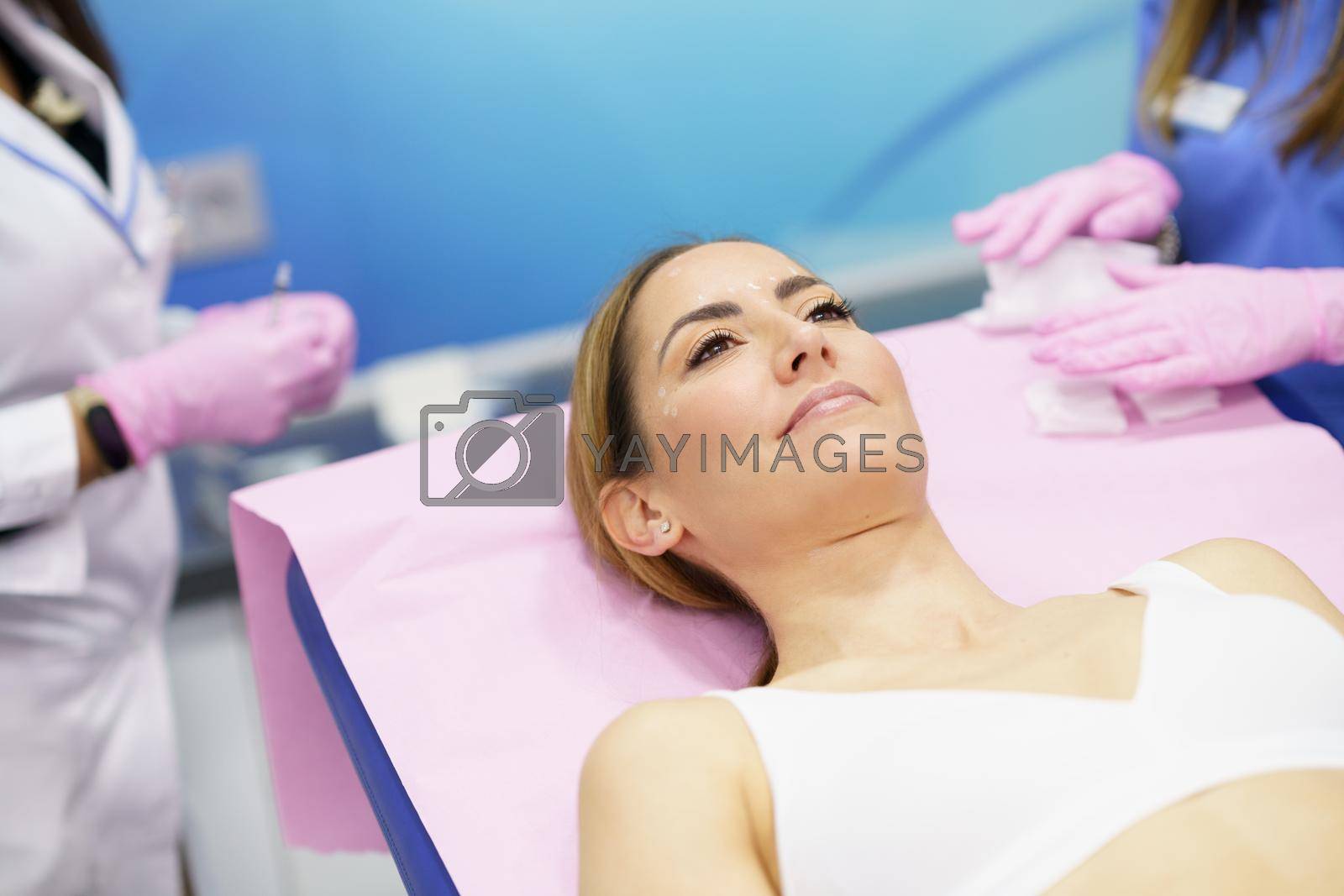 Royalty free image of Middle-aged woman lying on the stretcher in an aesthetic clinic. by javiindy