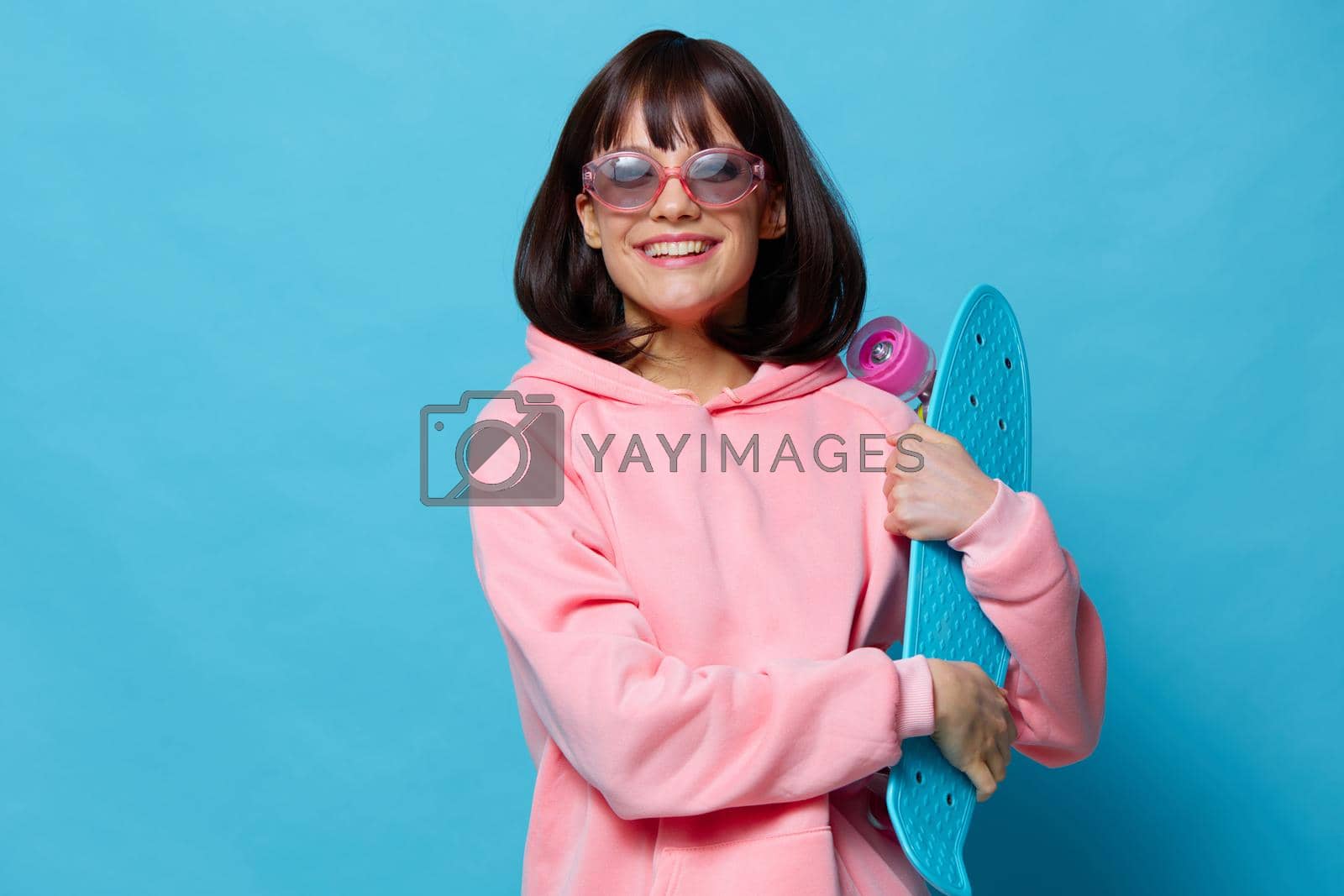 portrait woman in a pink sweater skateboard entertainment Lifestyle fashion. High quality photo