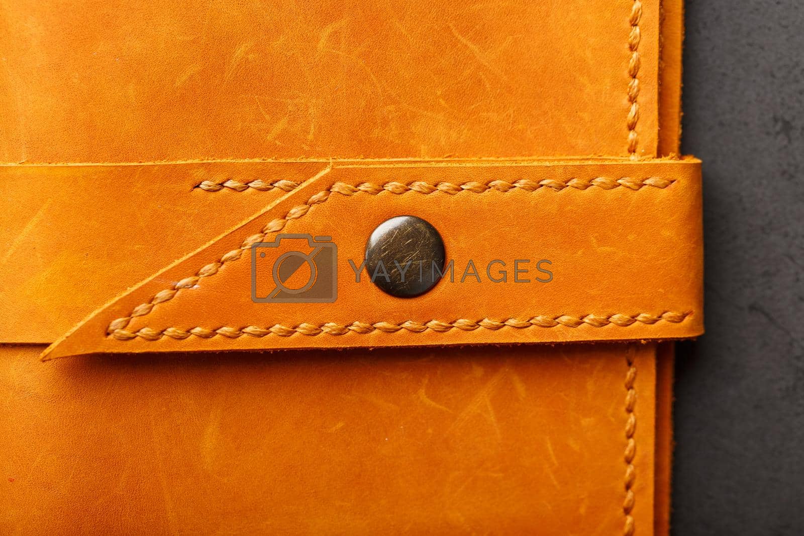 Royalty free image of Wallet made of genuine brown nubuck leather on a dark background. Handmade leather items by AlexGrec