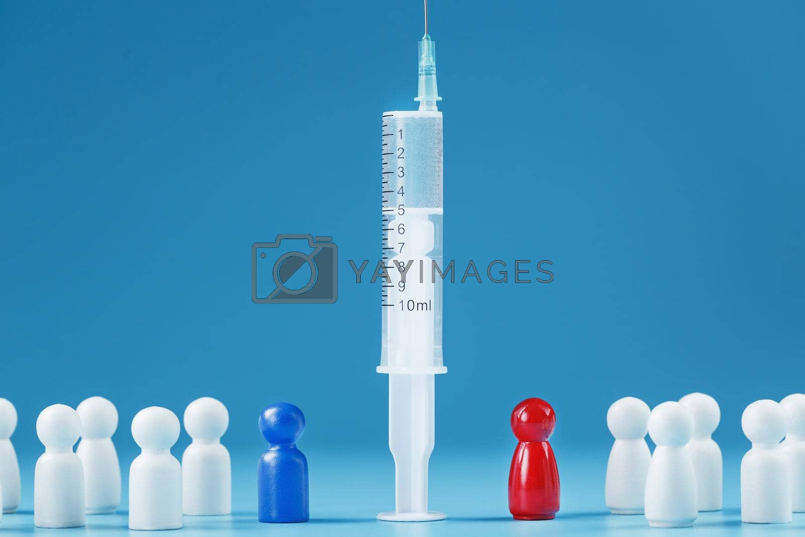 Royalty free image of Vaccinate or refuse a syringe with a vaccine with two groups of people a red and a blue human model. by AlexGrec