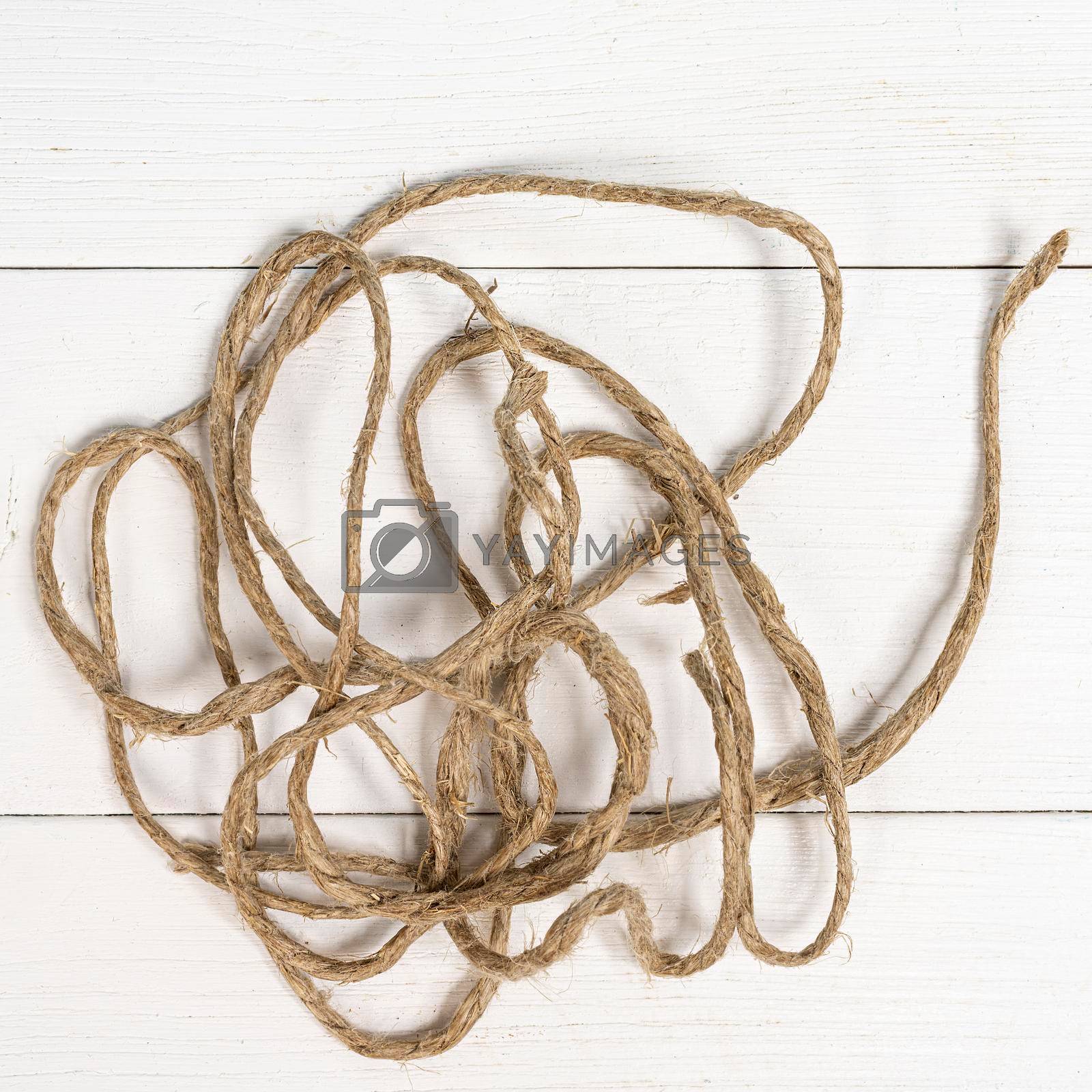 twine tangled on a white wooden surface