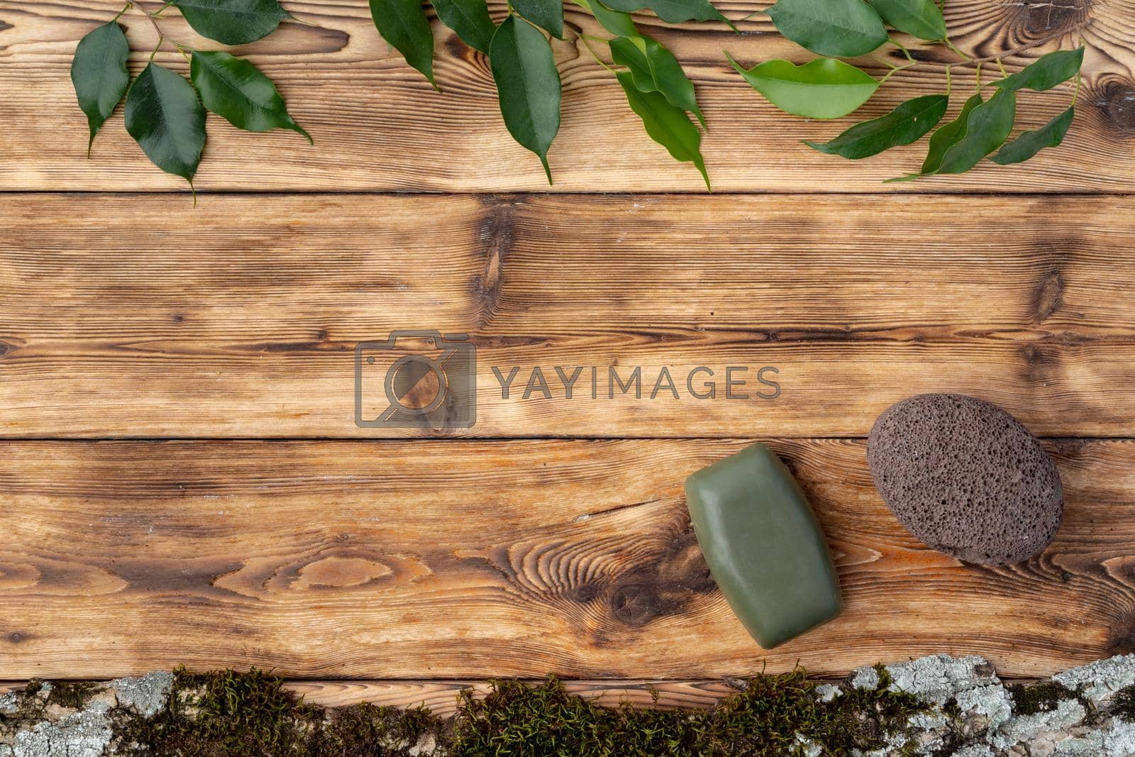 Spa photo with soap on rustic wooden background, top view