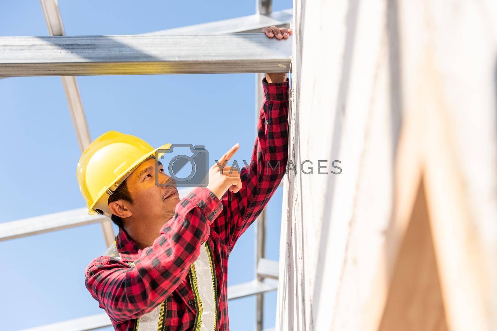 Royalty free image of Construction worker or contractor checking house frame by Sorapop