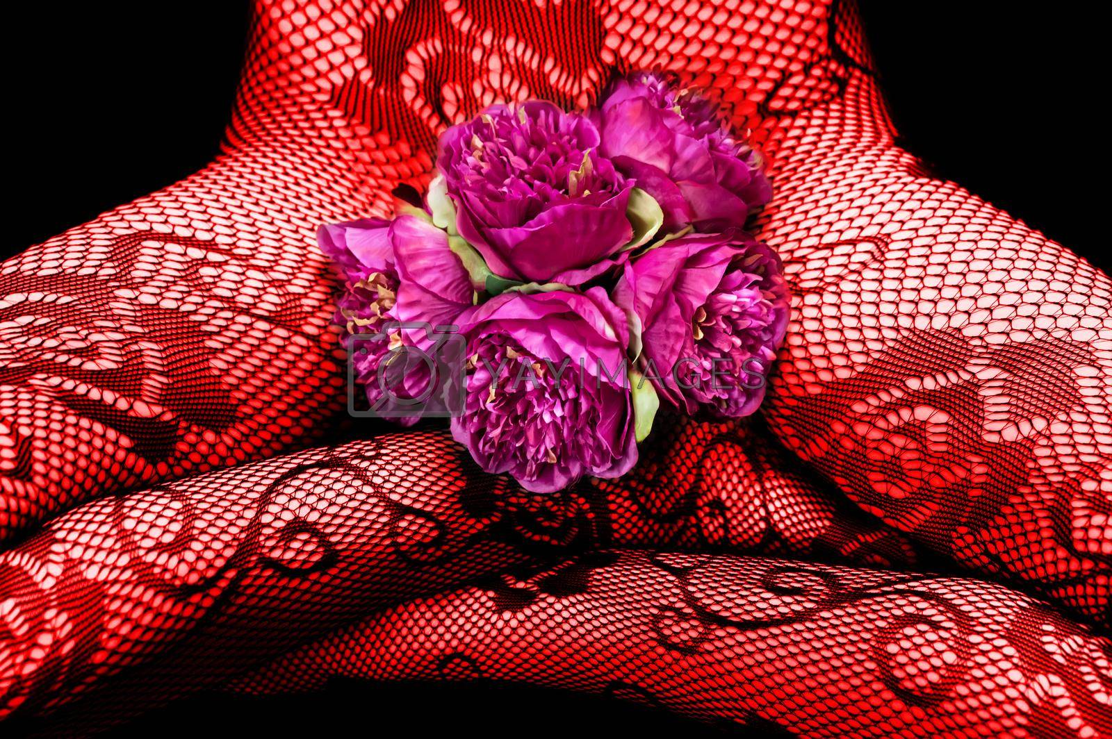Royalty free image of Woman in fishnet tights with pink peonies by palinchak