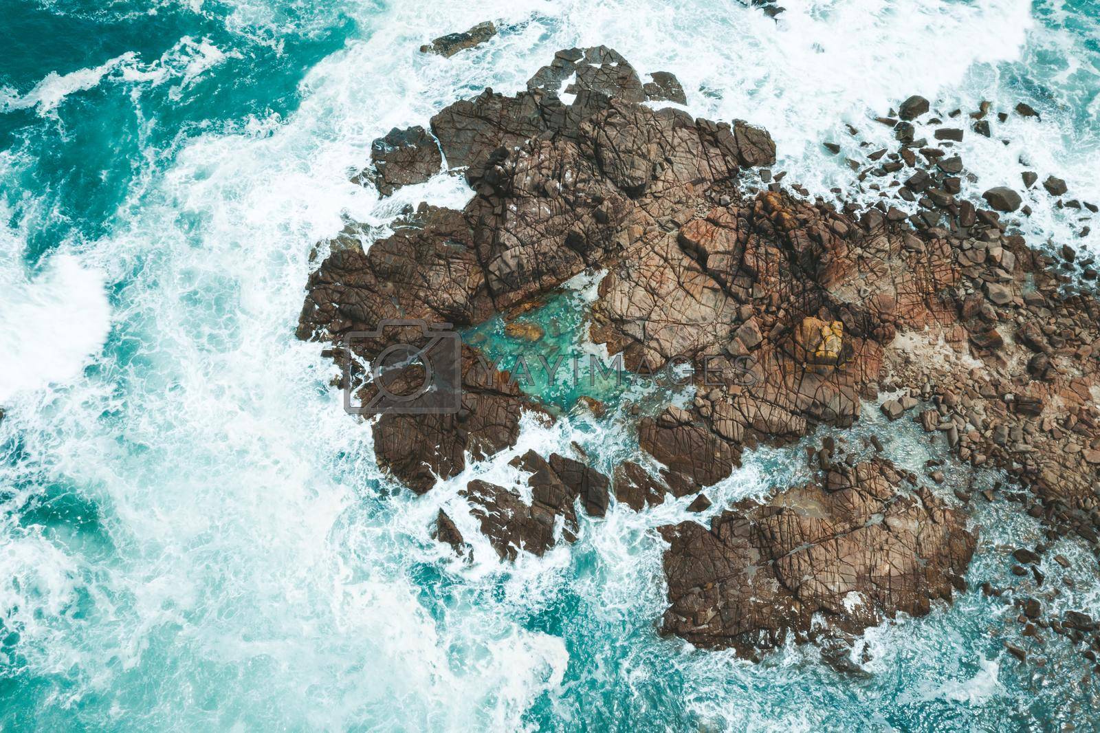 Royalty free image of Aerial drone shot of ocean waves around rocks and rock pool by lovleah
