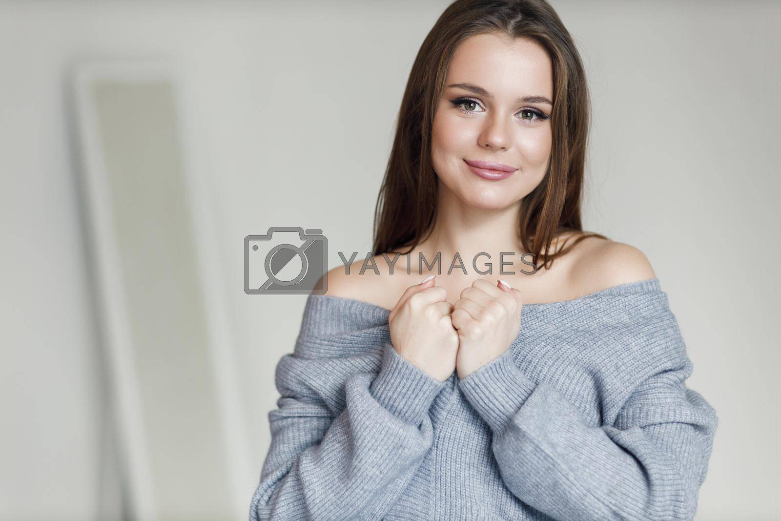 Royalty free image of Young beautiful cozy woman indoor by splash