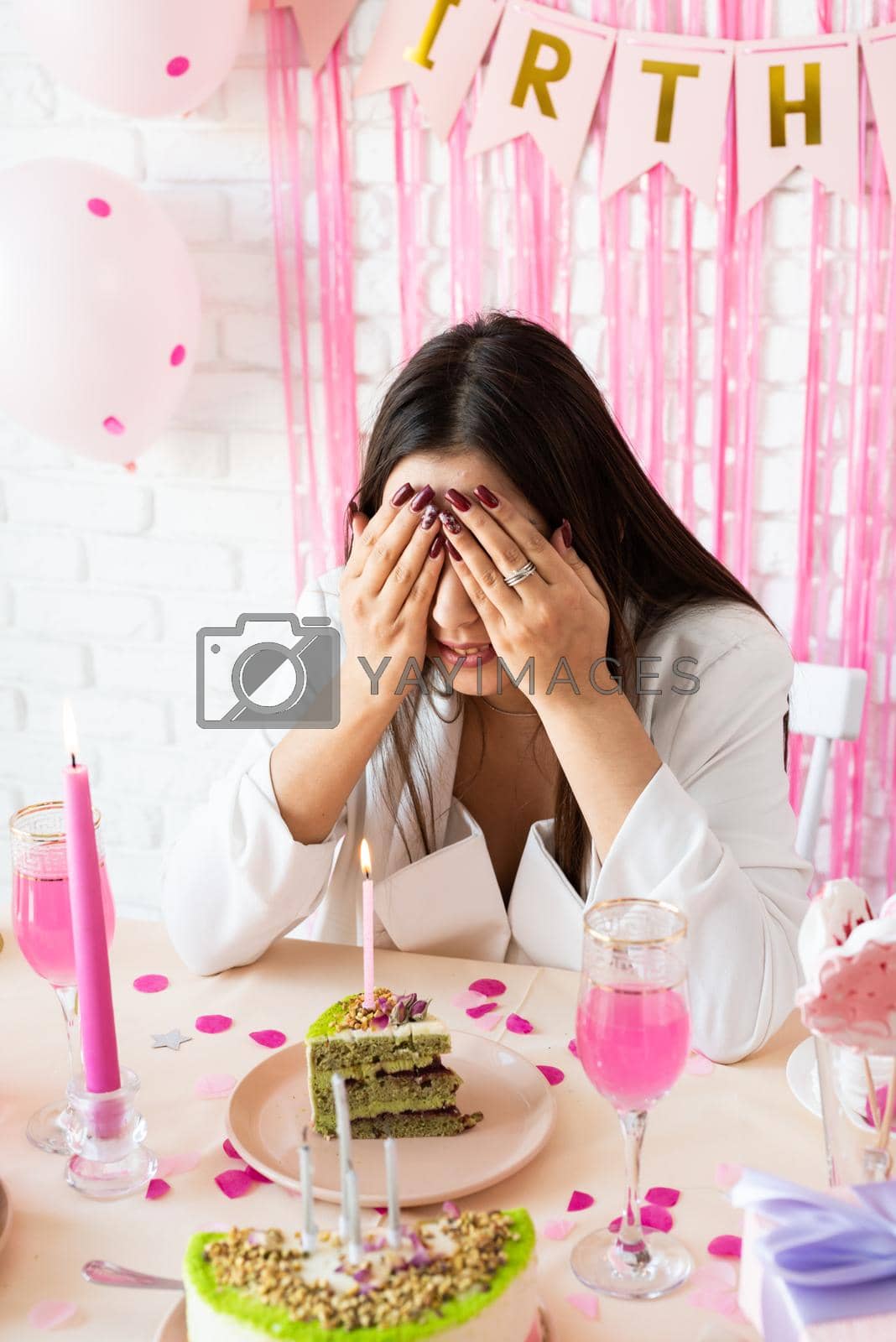 Royalty free image of Beautiful excited woman celebrating birthday party making wish by Desperada