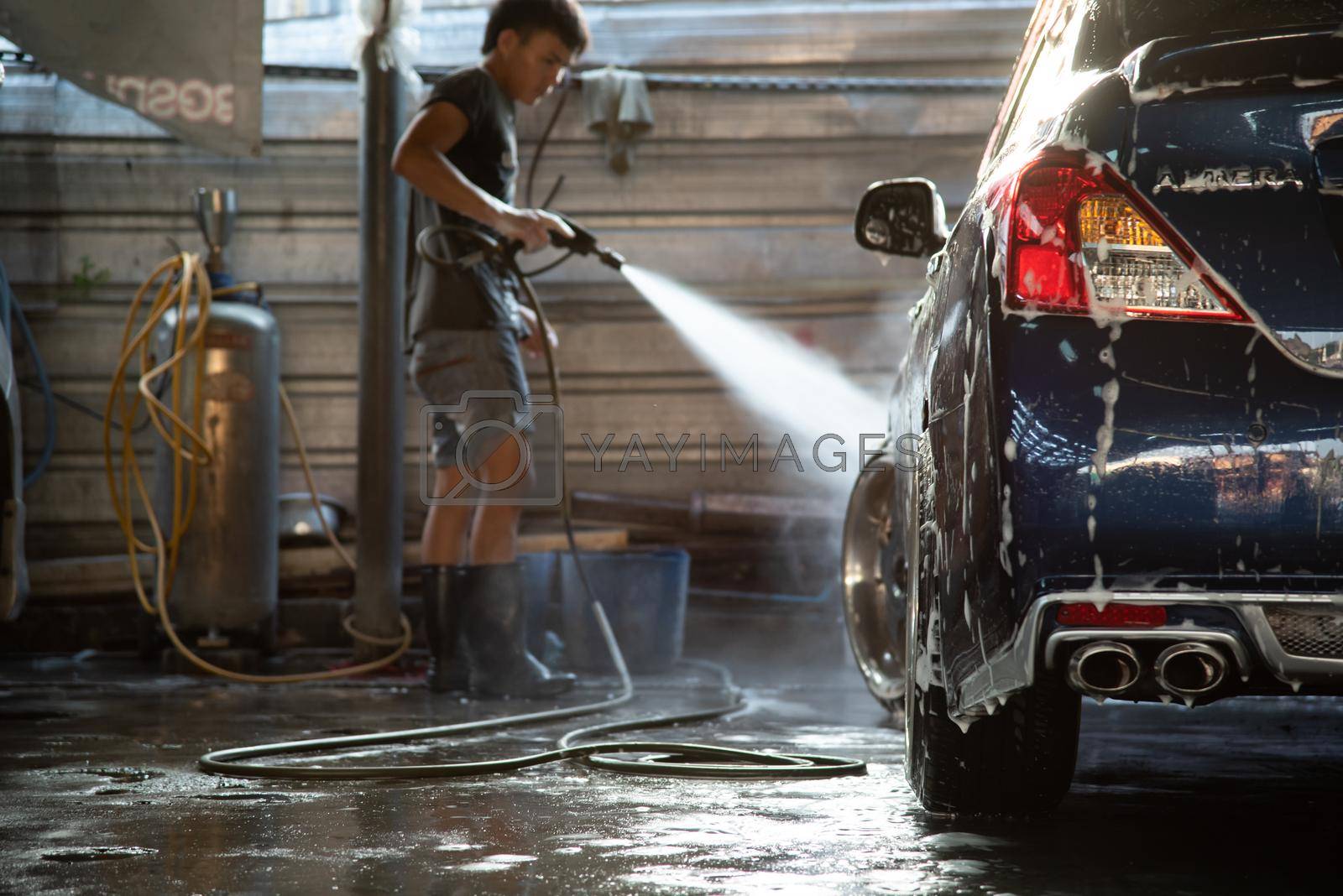 Bangkok, Thailand - March 31, 2017 : Unidentified car care staff cleaning (clean, wash, polish, wax and glass coating) the car (Car detailing) at car care shop in Bangkok Thailand