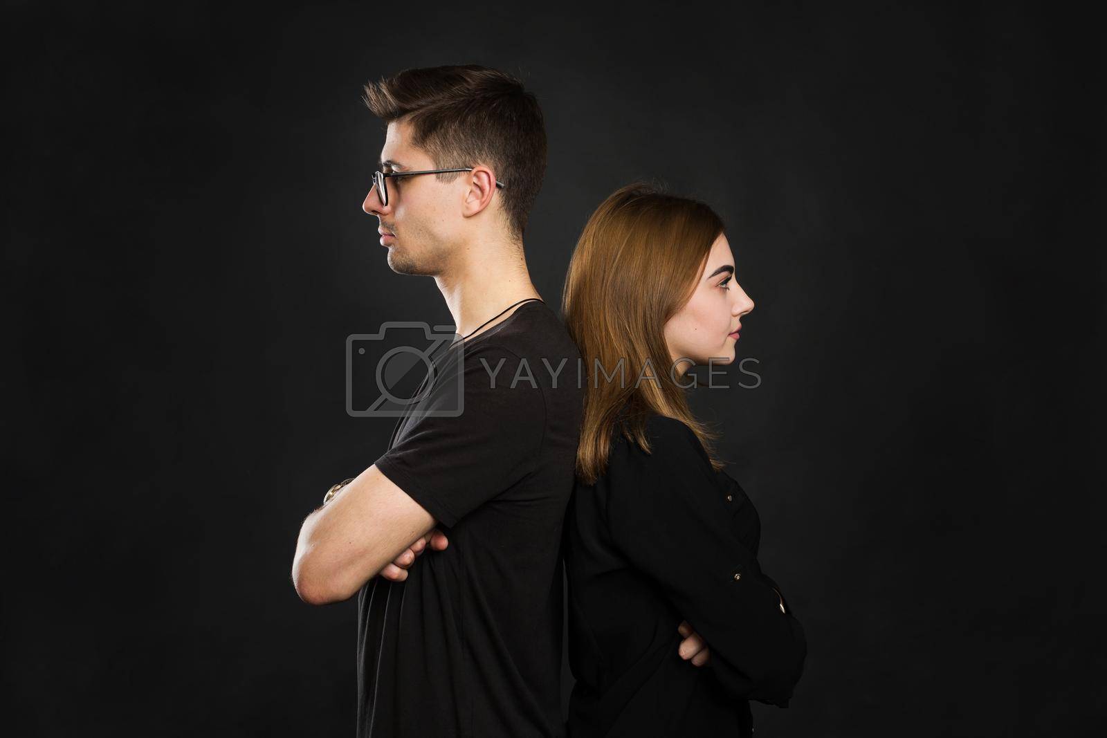 Royalty free image of Couple back to back not talking after an argument on black screen. by StudioPeace