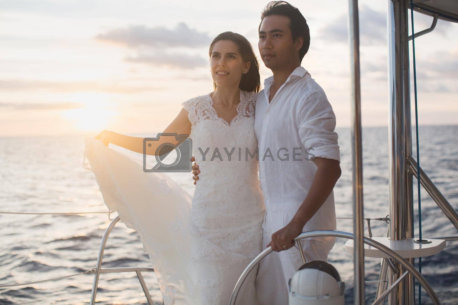 Wedding couple is hugging on a yacht. Beauty bride with groom.