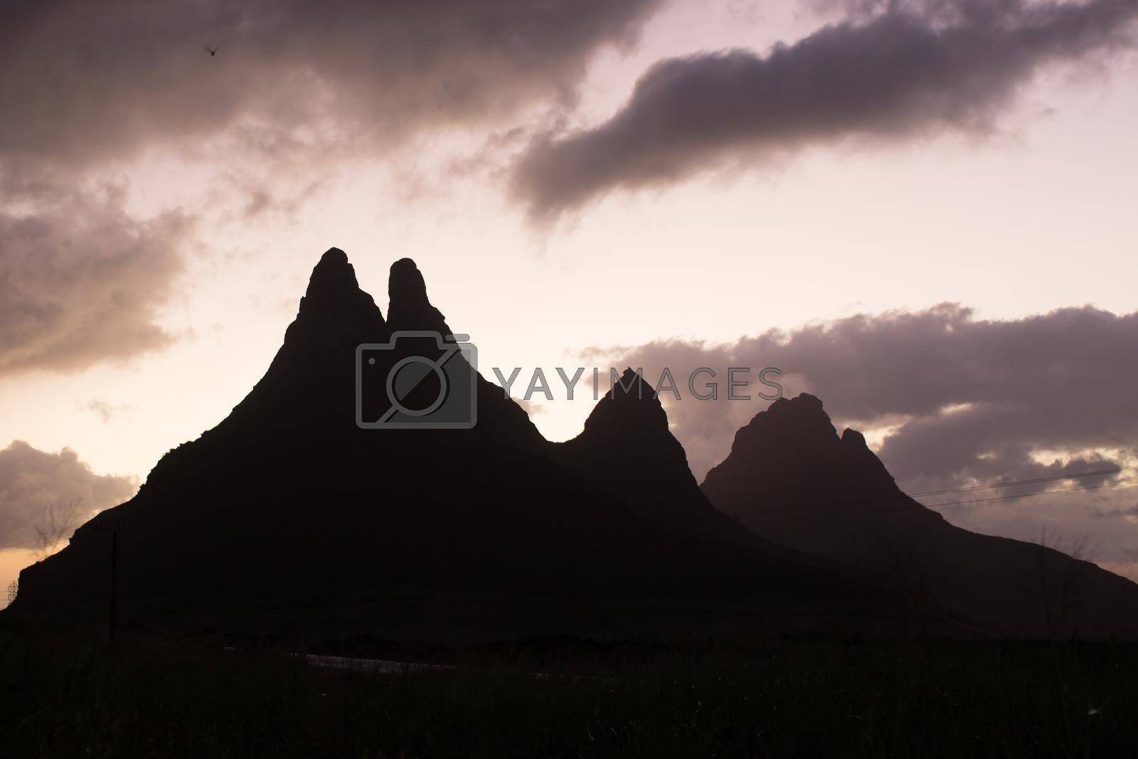 Royalty free image of Silhouette of a mountain range at sunset by StudioPeace