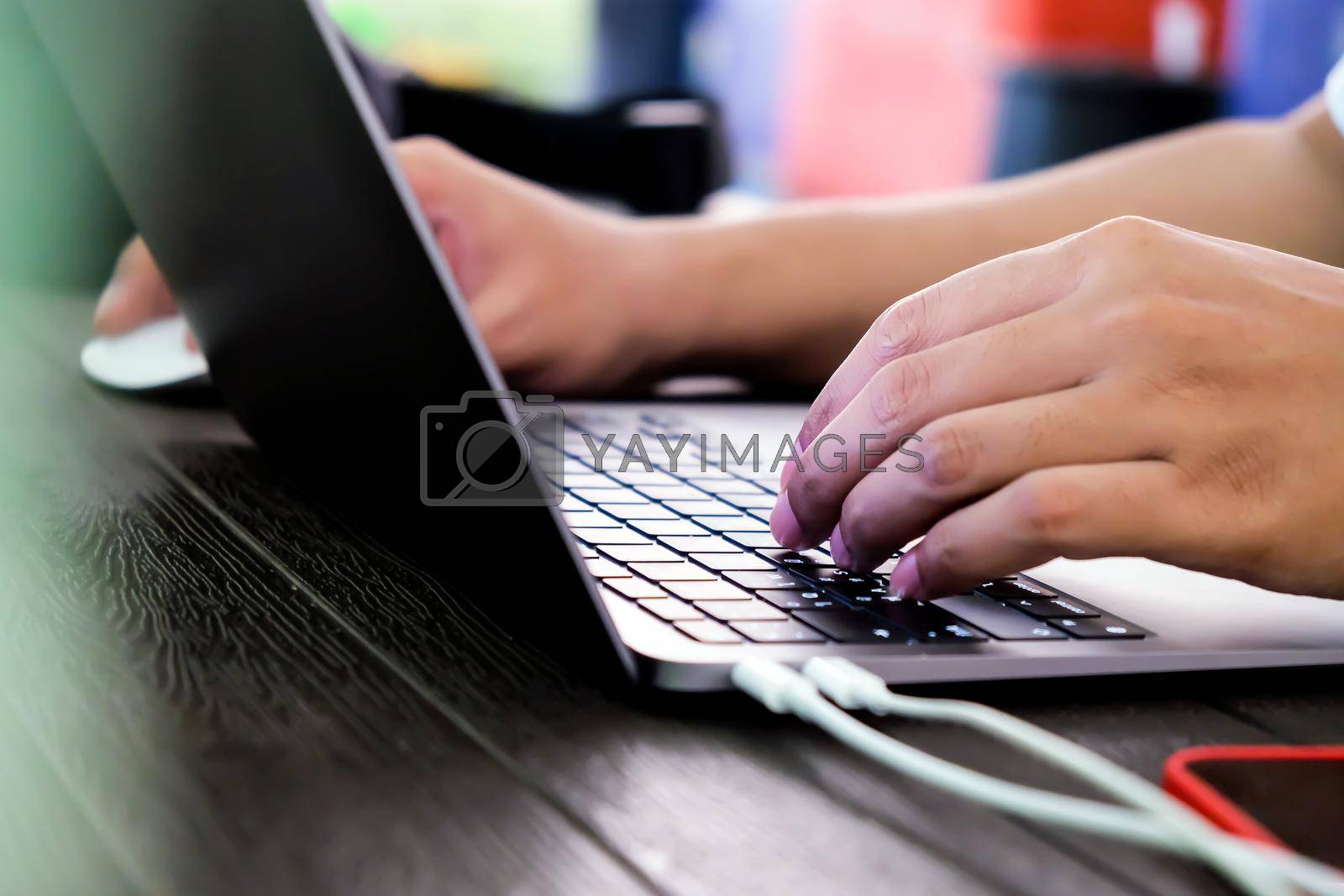 Royalty free image of hands of businessman typing on laptop keyboard by ponsulak